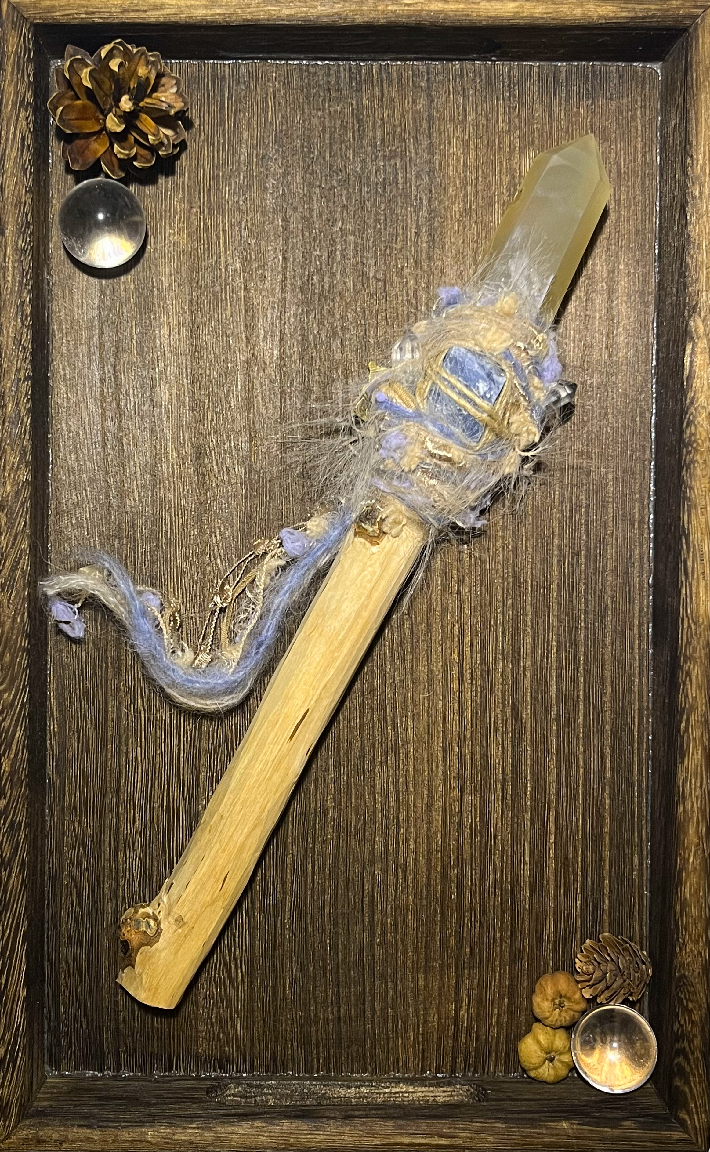 Flat lay of forest dawn wand with gentle yellow agate and dreamy pastel tones