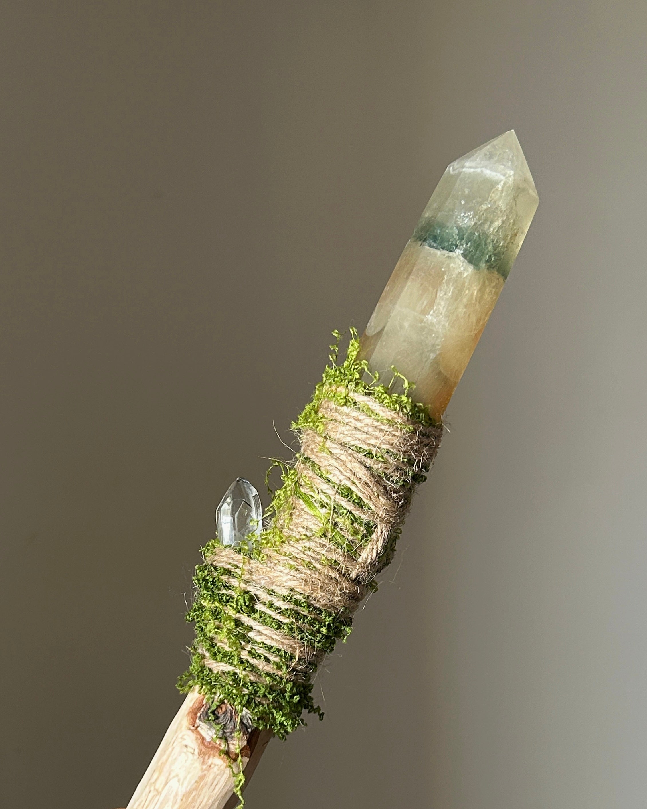 Back view of nature ritual wand with green fluorite cluster and clear quartz accent