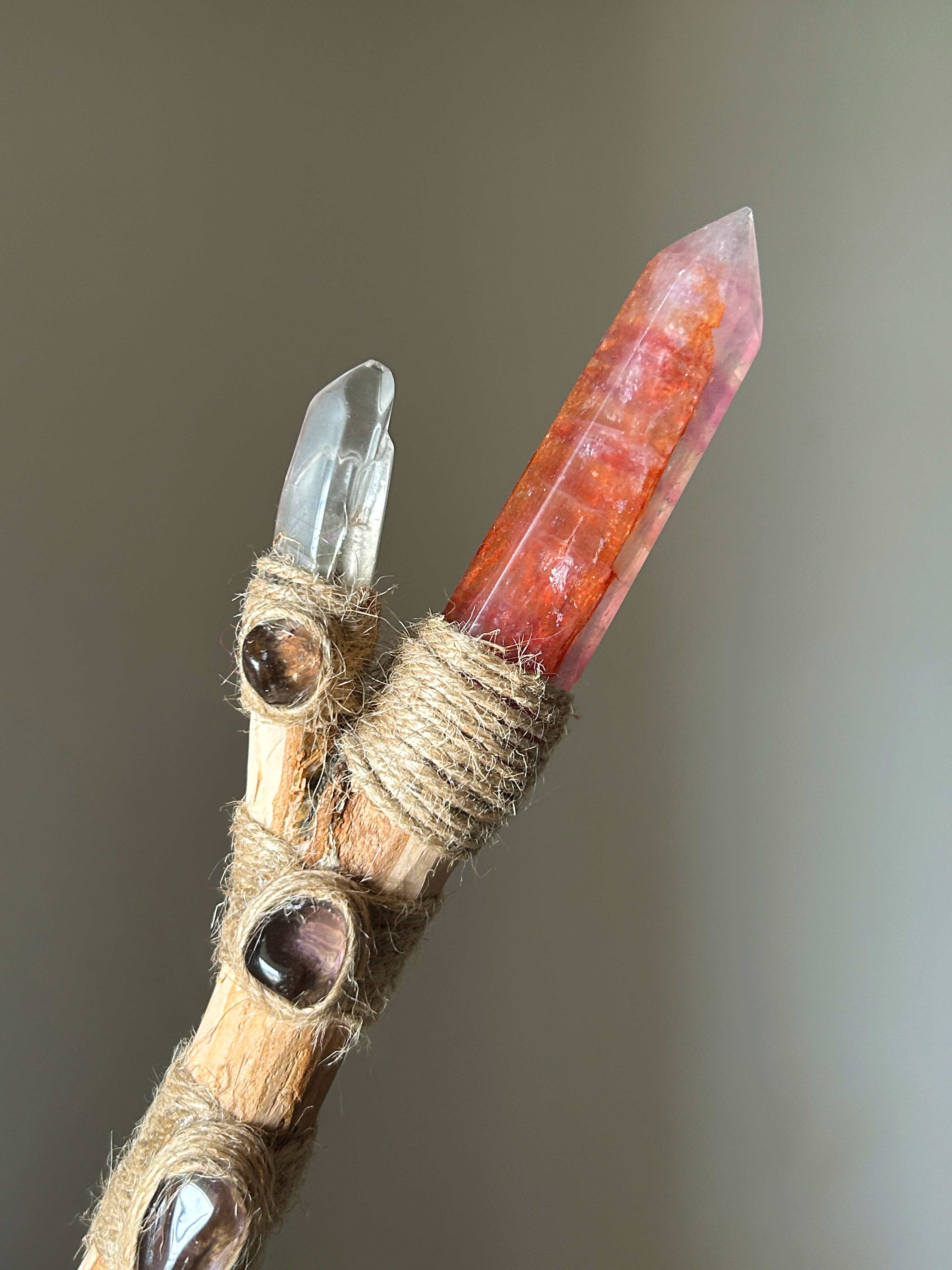 Close-up of crystal tip and embedded smoky quartz stones with raw jute wrapping