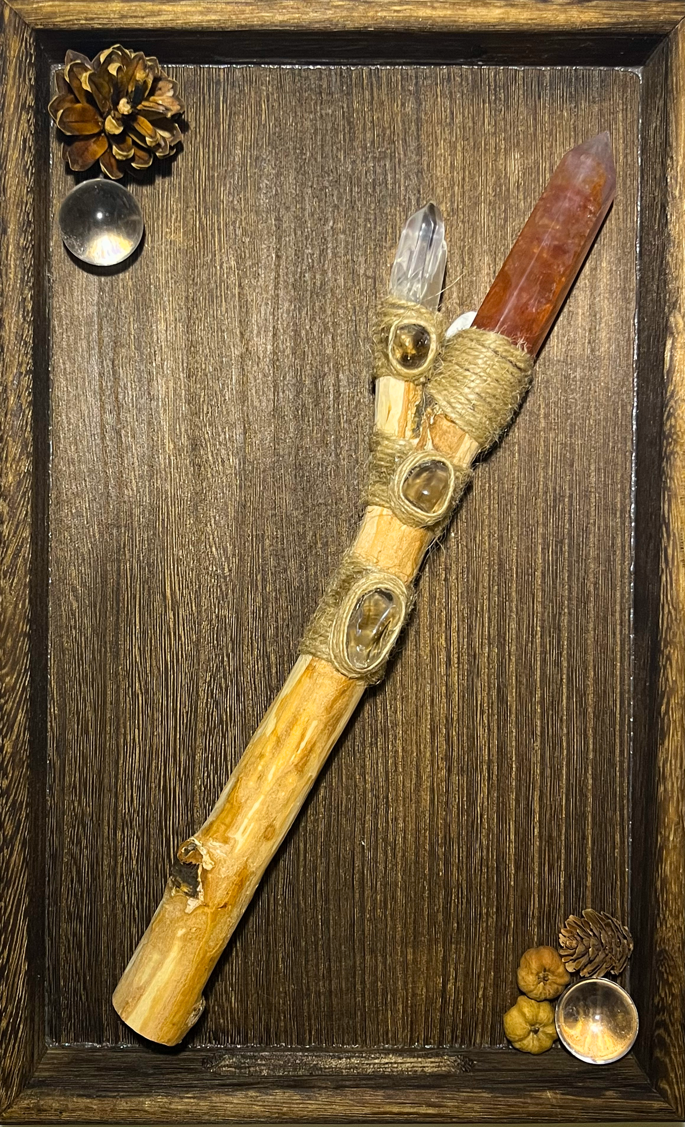 Flat lay of orange fluorite and smoky quartz ritual wand for discipline magic
