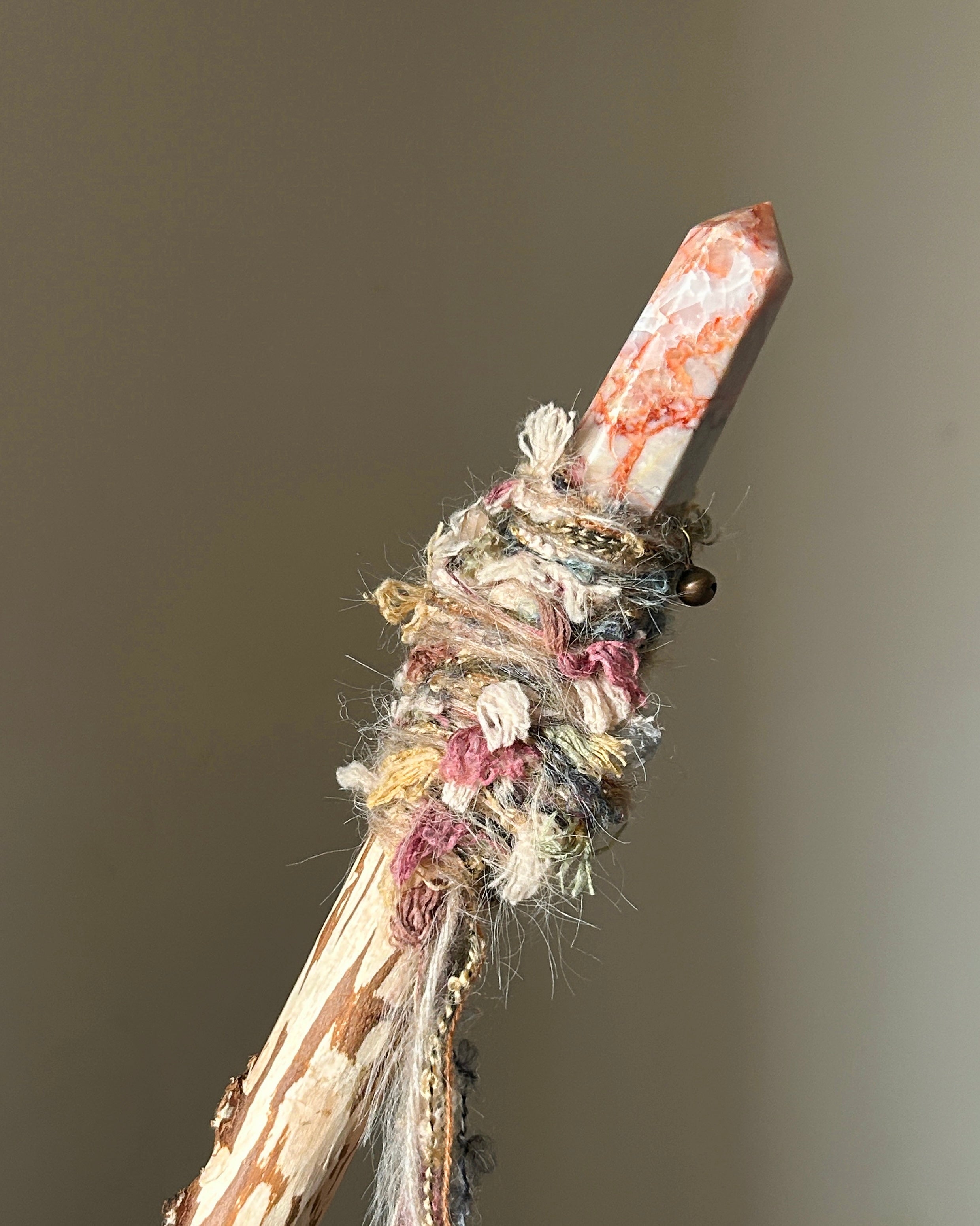 Back view showing fiber wrap and bell charm of sacred heart wand