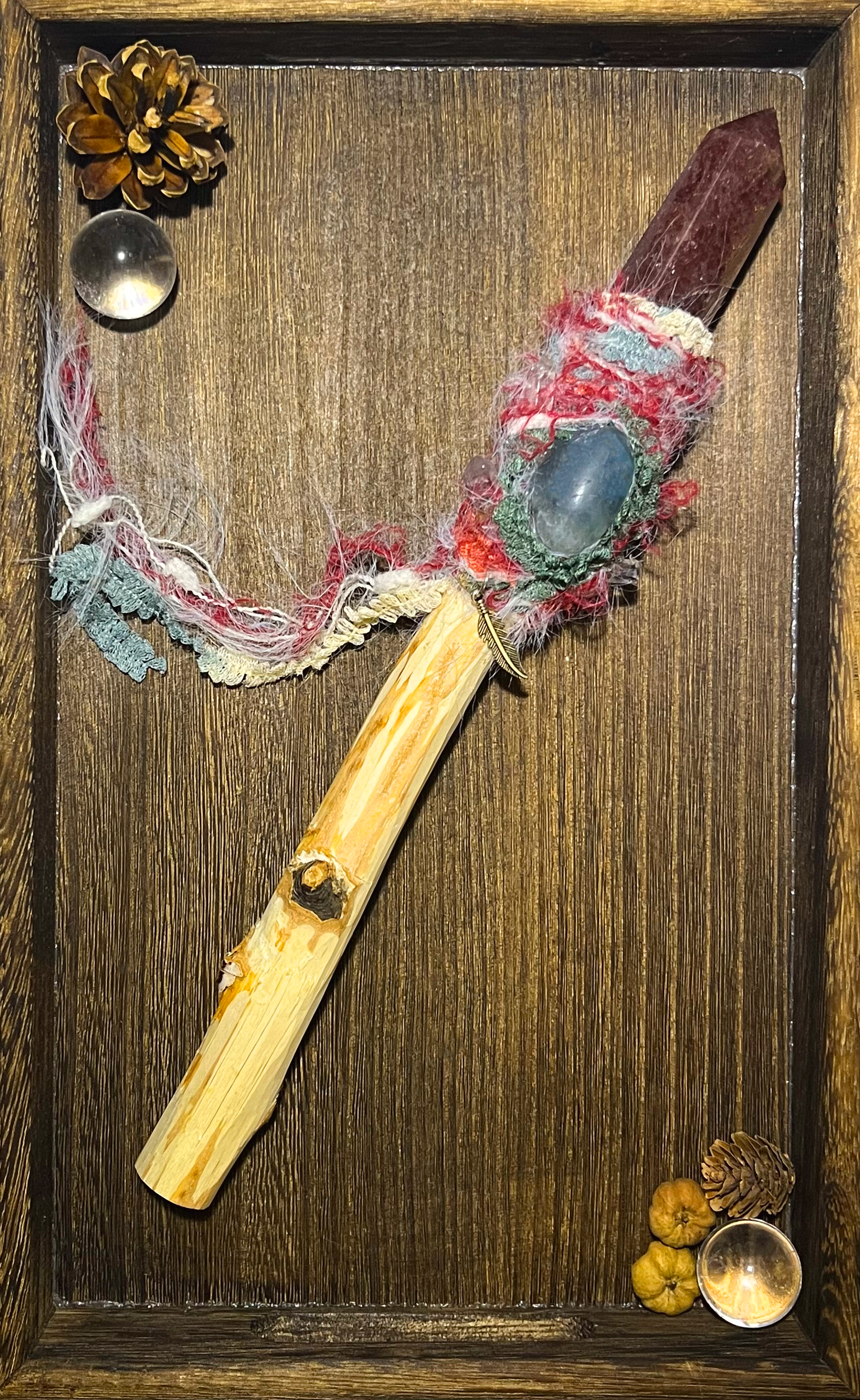 Full flatlay image of handcrafted heart-healing wand with soft yarn wrap