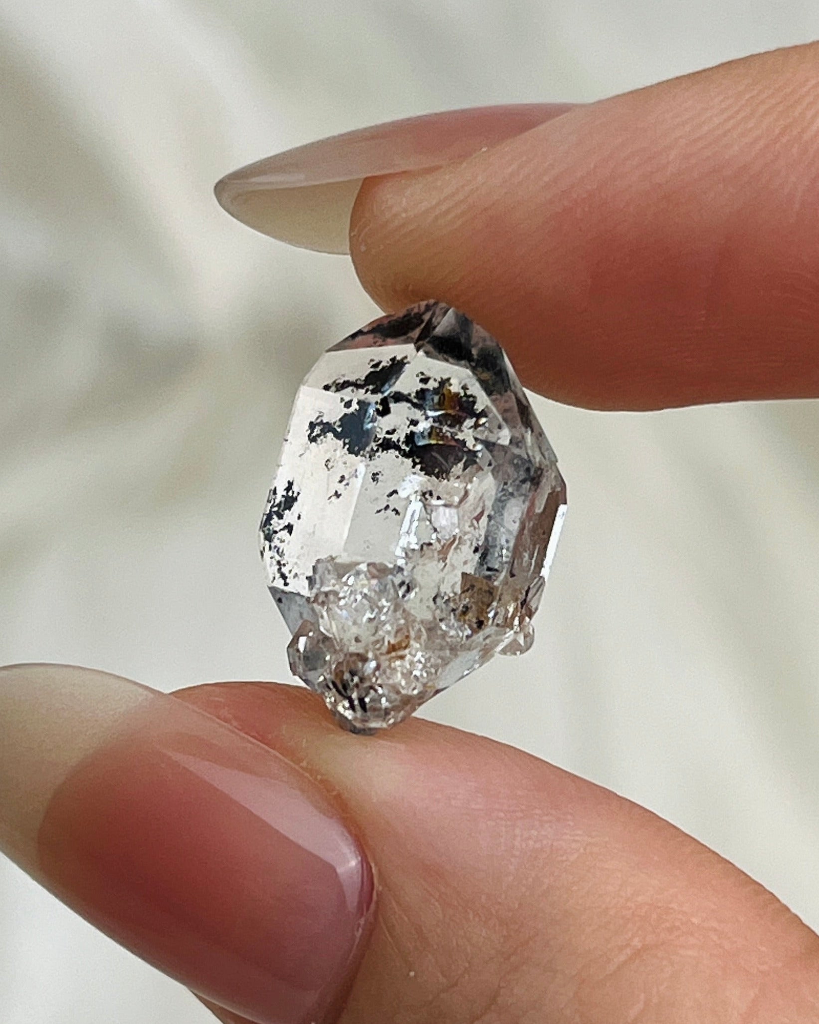 Water-clear Chongqing Diamond Quartz with rainbow reflections, calcite inclusion, and natural pit marks from China