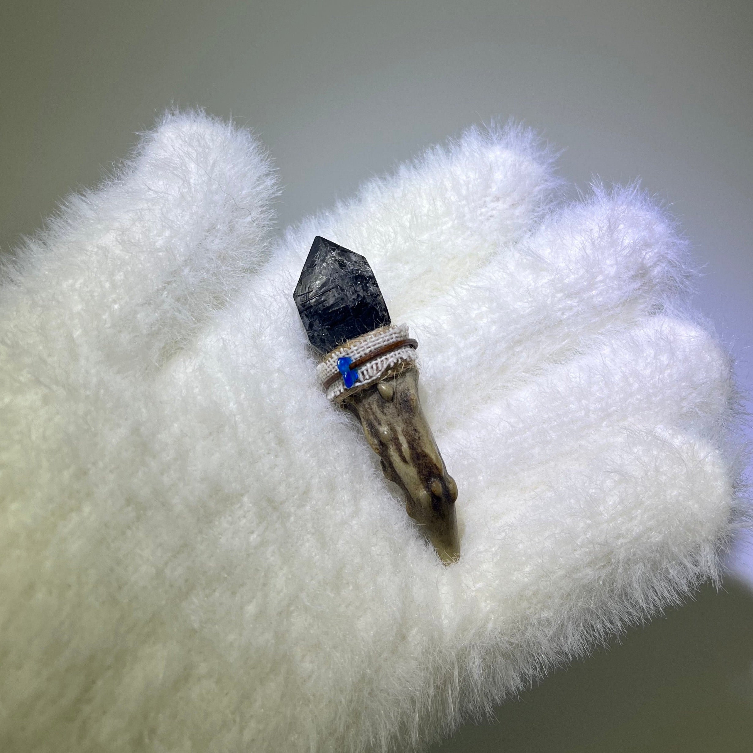 Graphite Phantom Antler Wand with Blue Apatite accent, mounted on a naturally shed deer antler and wrapped in beige thread.