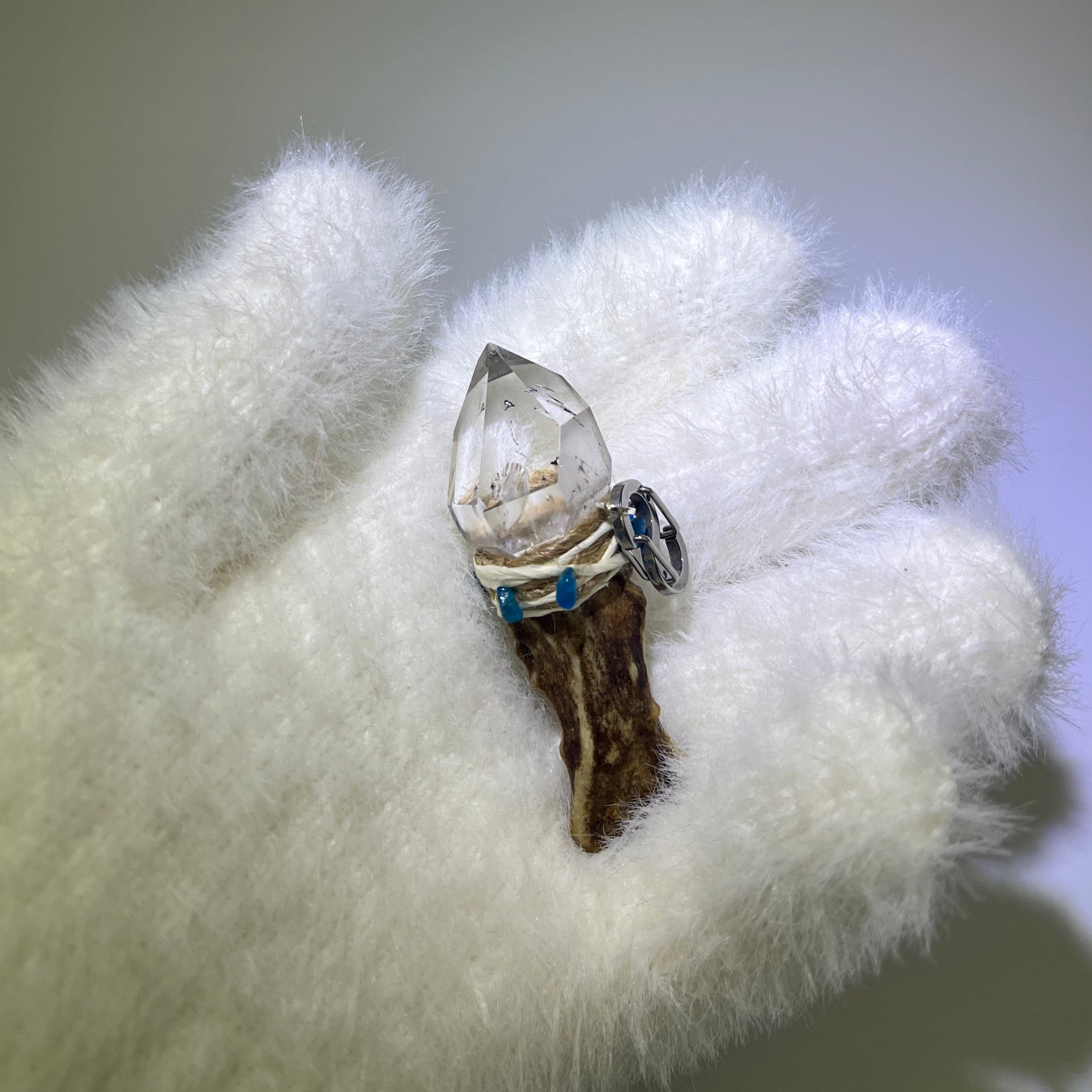 Handcrafted deer antler pendant with high-clarity phantom quartz, water inclusion, and blue apatite gemstones