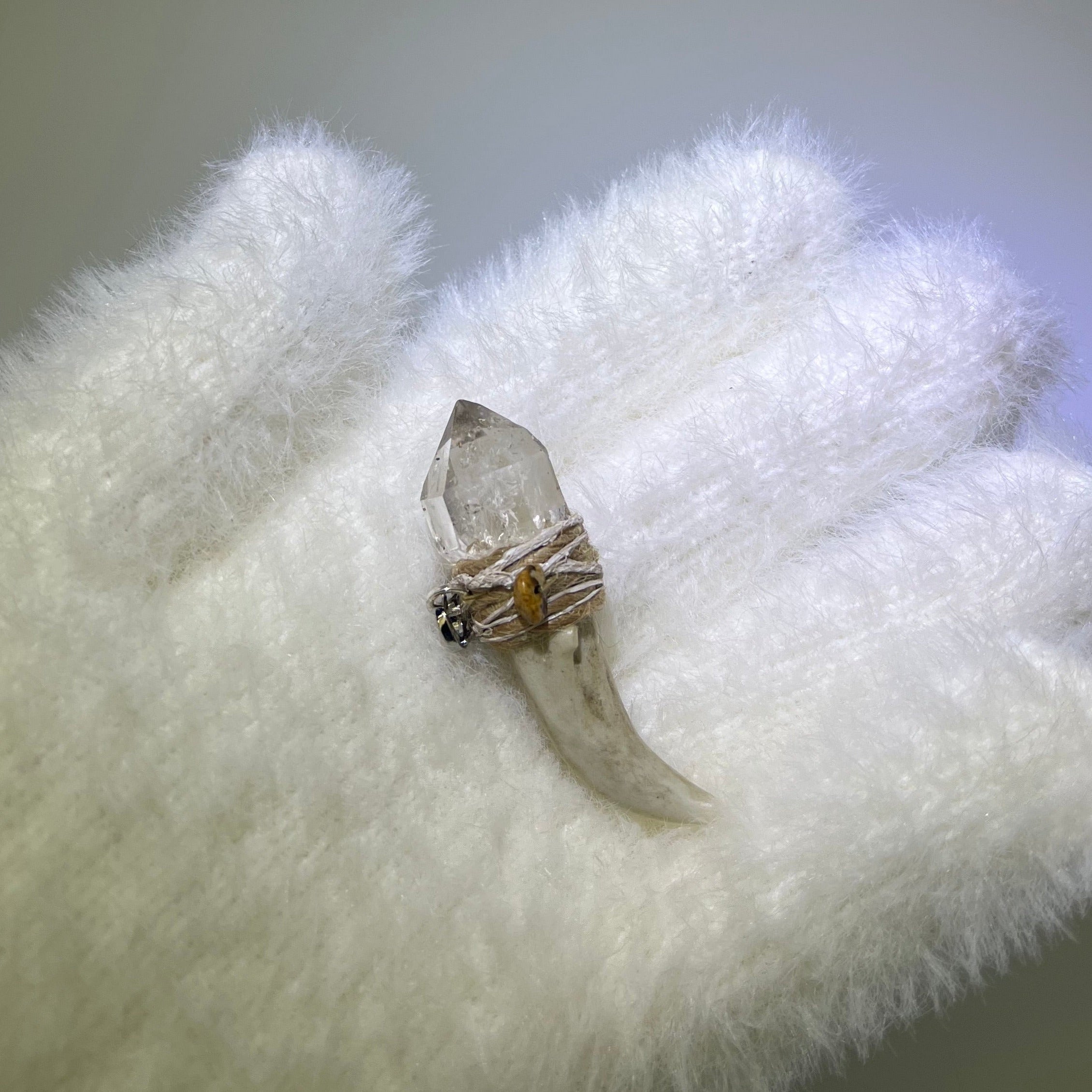 Ice Phantom Quartz Antler Pendant with rainbow inclusions, beige thread, and Picture Jasper accent on white glove
