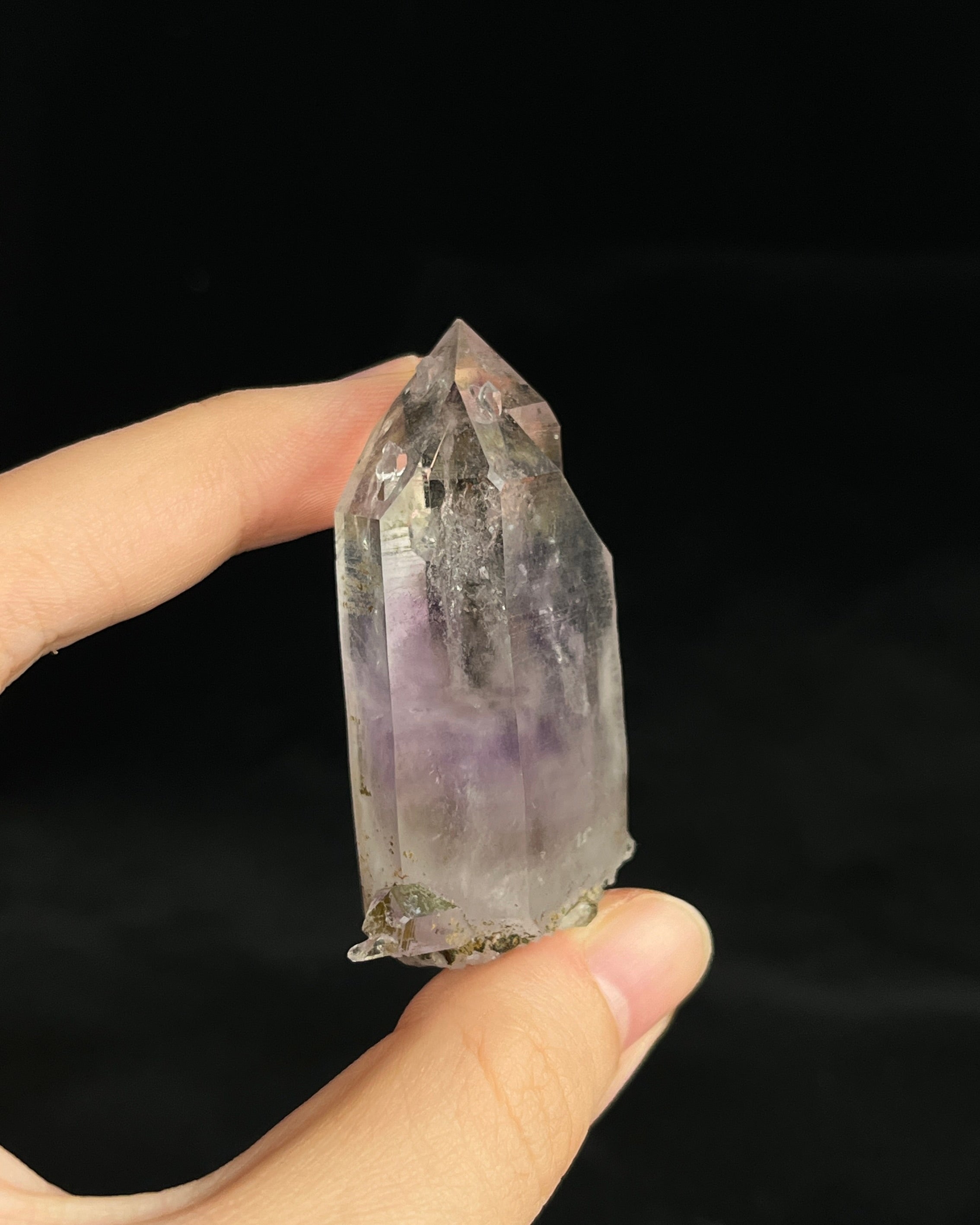 Soft lavender amethyst with self-healed regrowth crystals and a light chlorite coating near the base.2