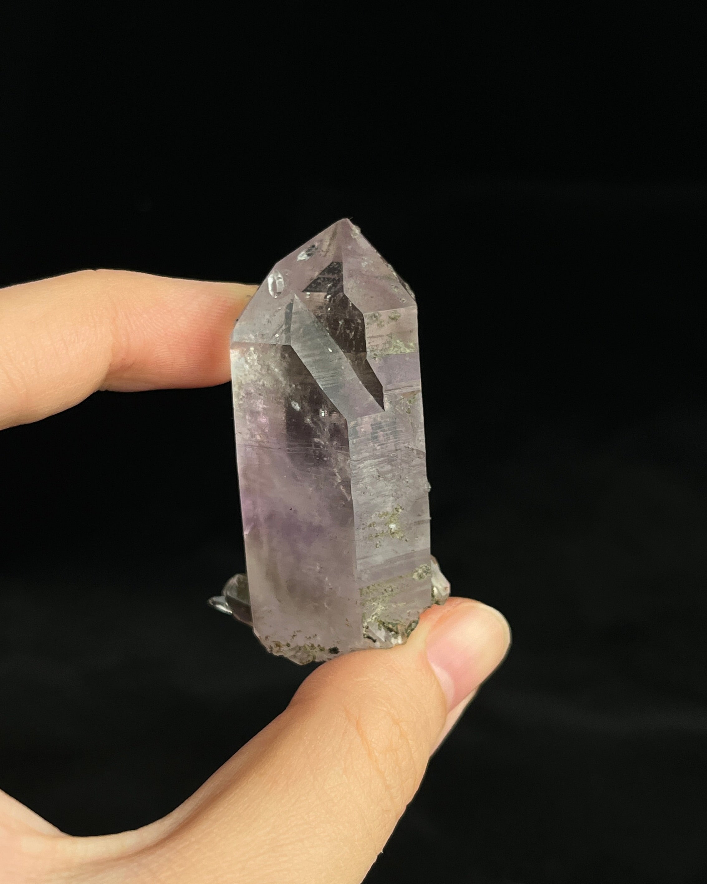 Soft lavender amethyst with self-healed regrowth crystals and a light chlorite coating near the base.3