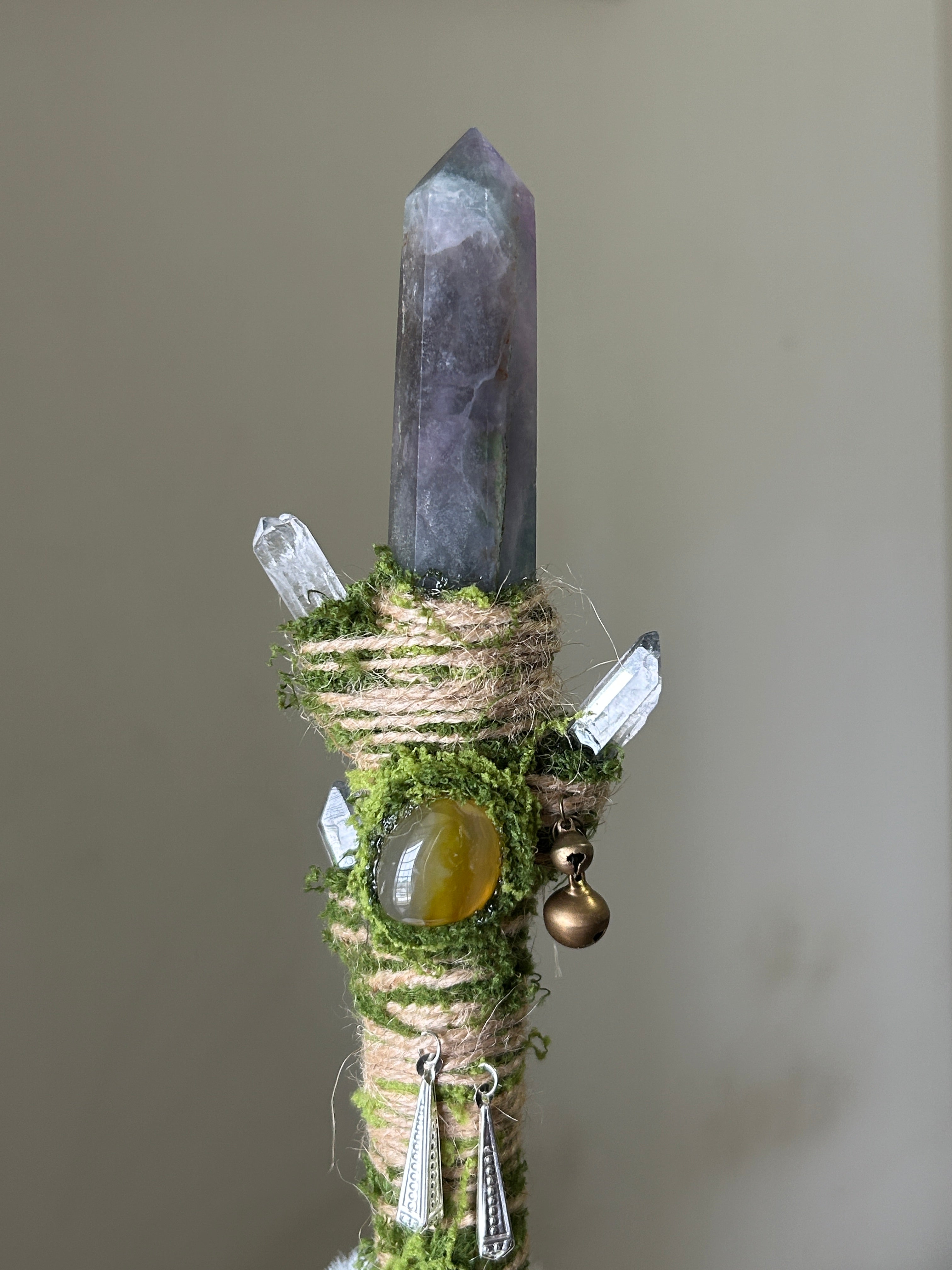 Close-up of green fluorite, kyanite, and moss-wrapped wand with silver butterfly