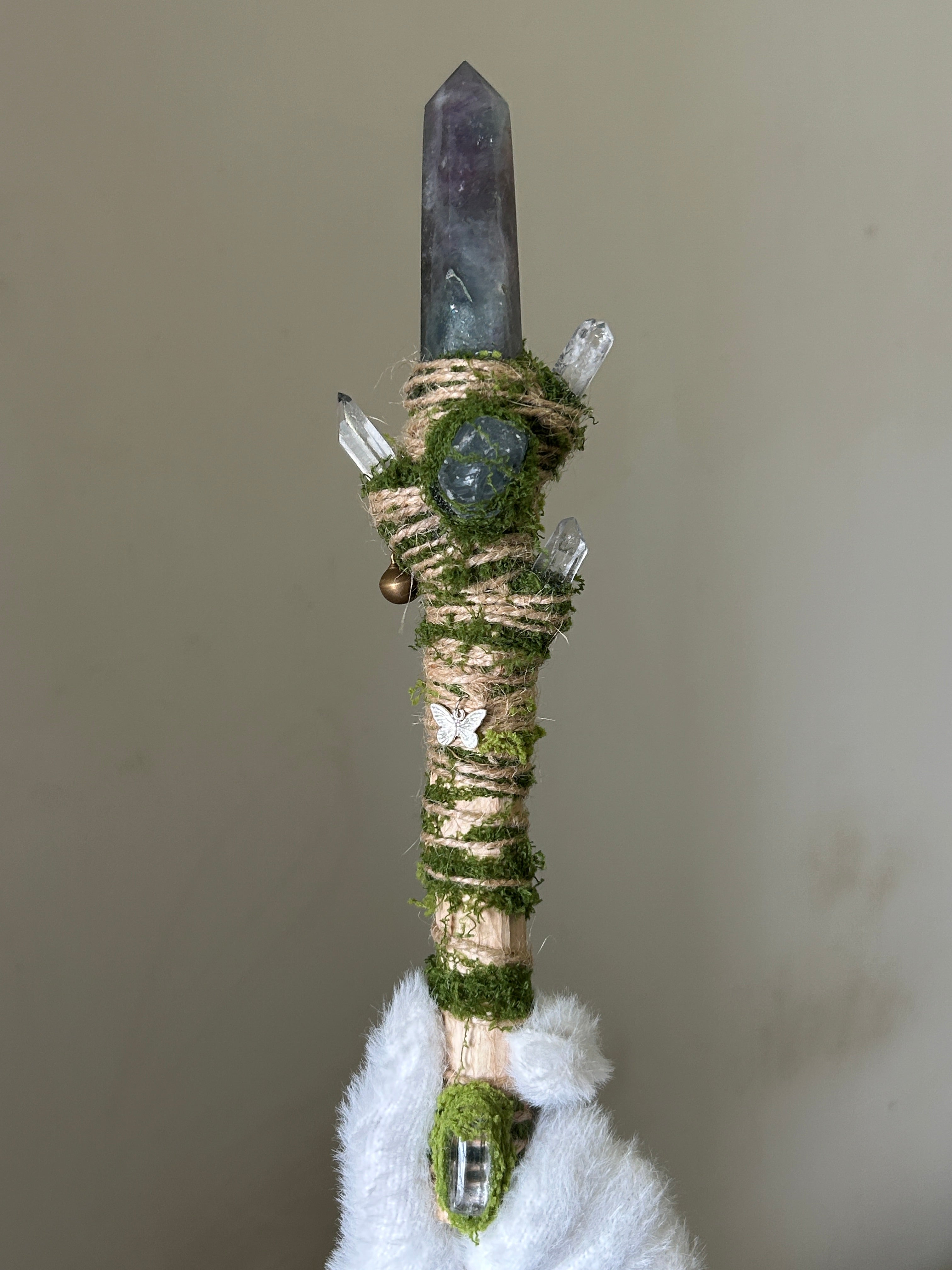 Front view of birch wand with green fluorite tip and crystal cluster