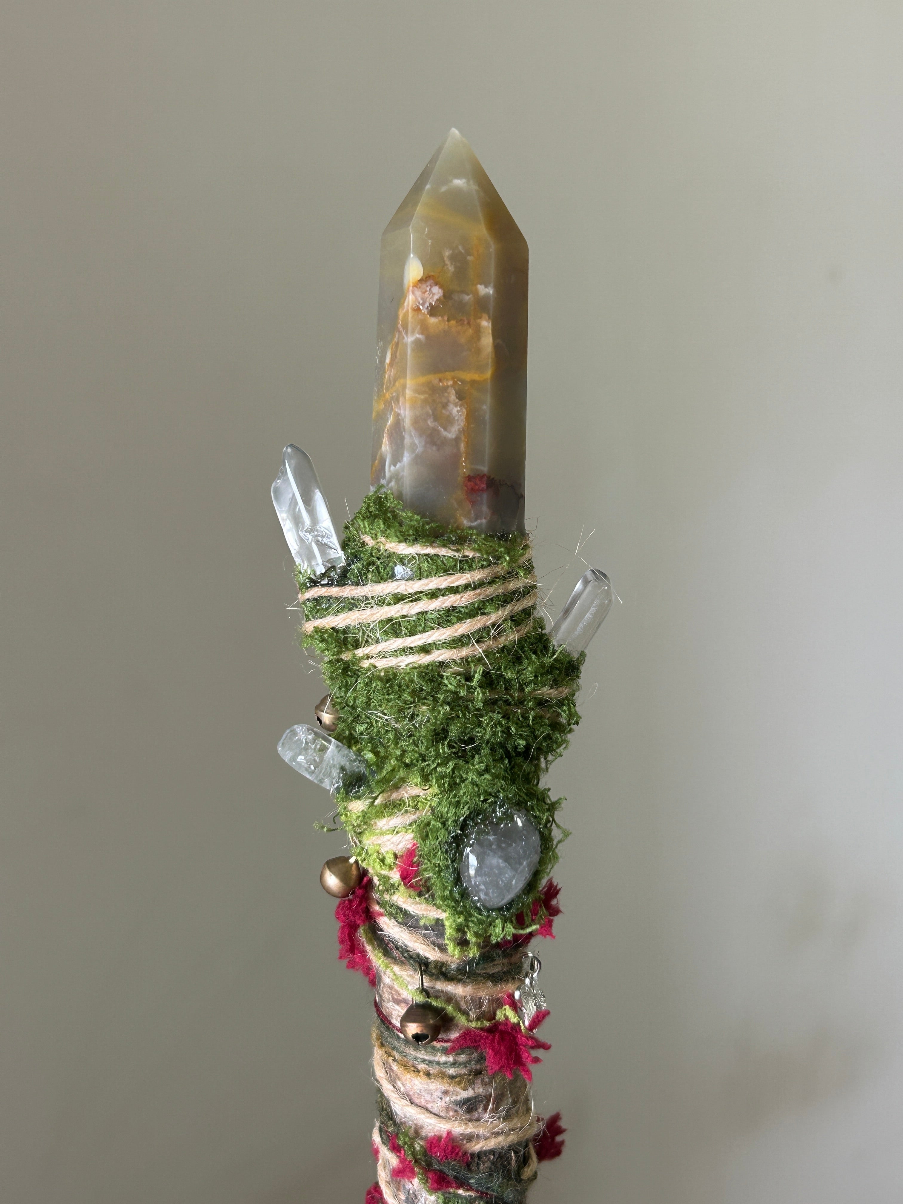 Close-up of red agate point, green fluorite, and mossy wrap on birch wand