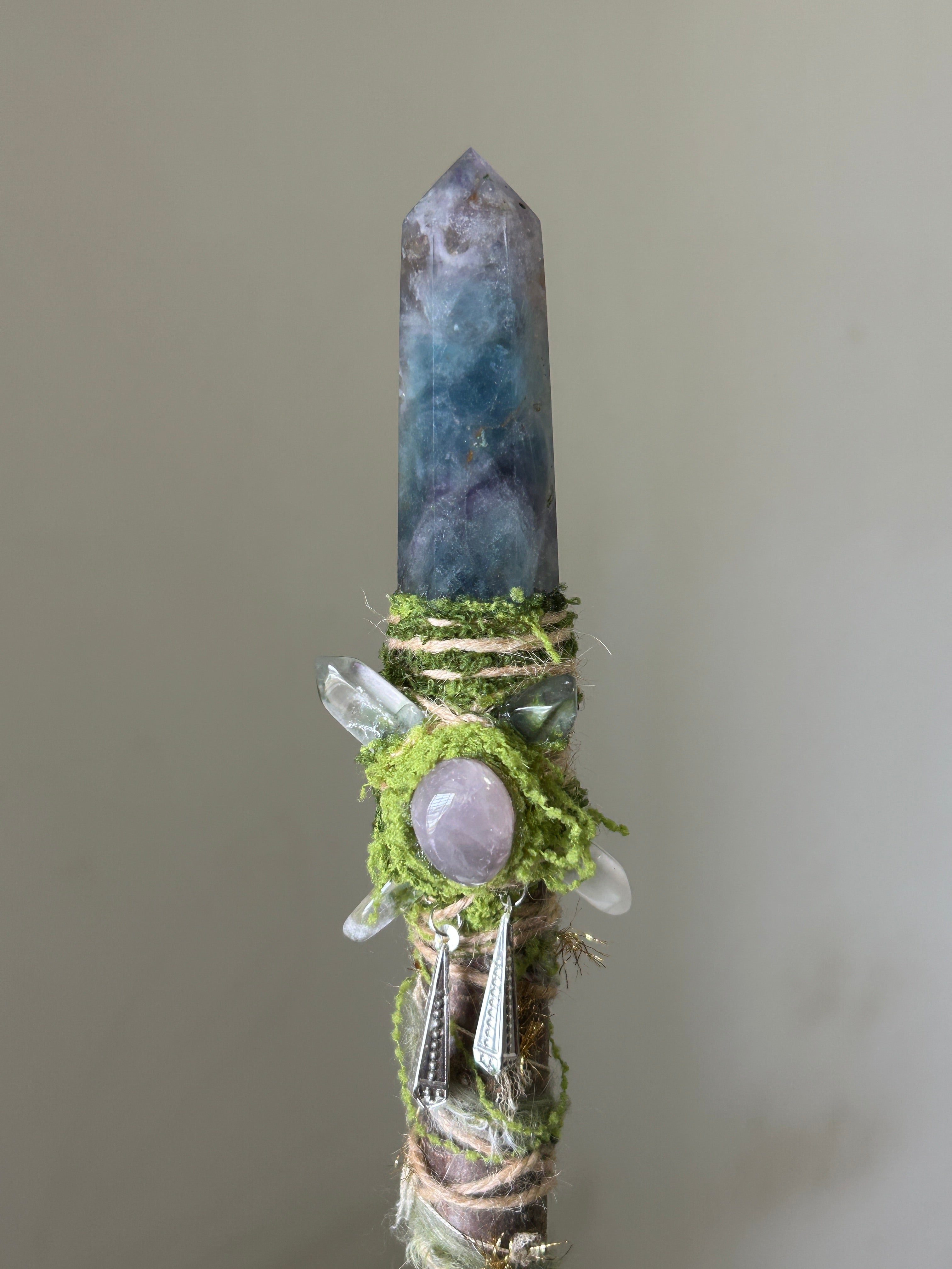 Close-up of green fluorite point with moss and rose quartz sphere
