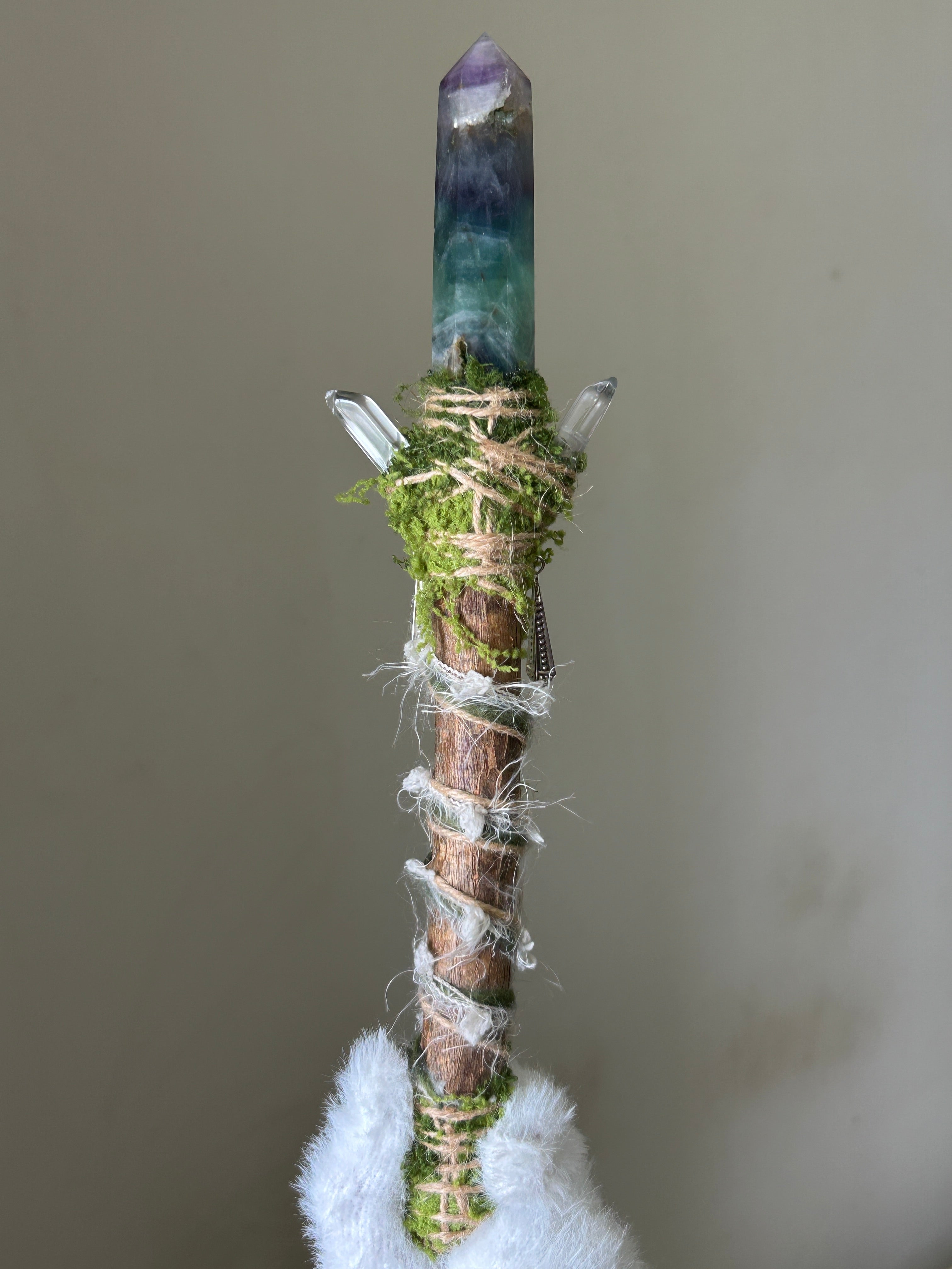 Back view of willow wand with soft fibers and butterfly charm
