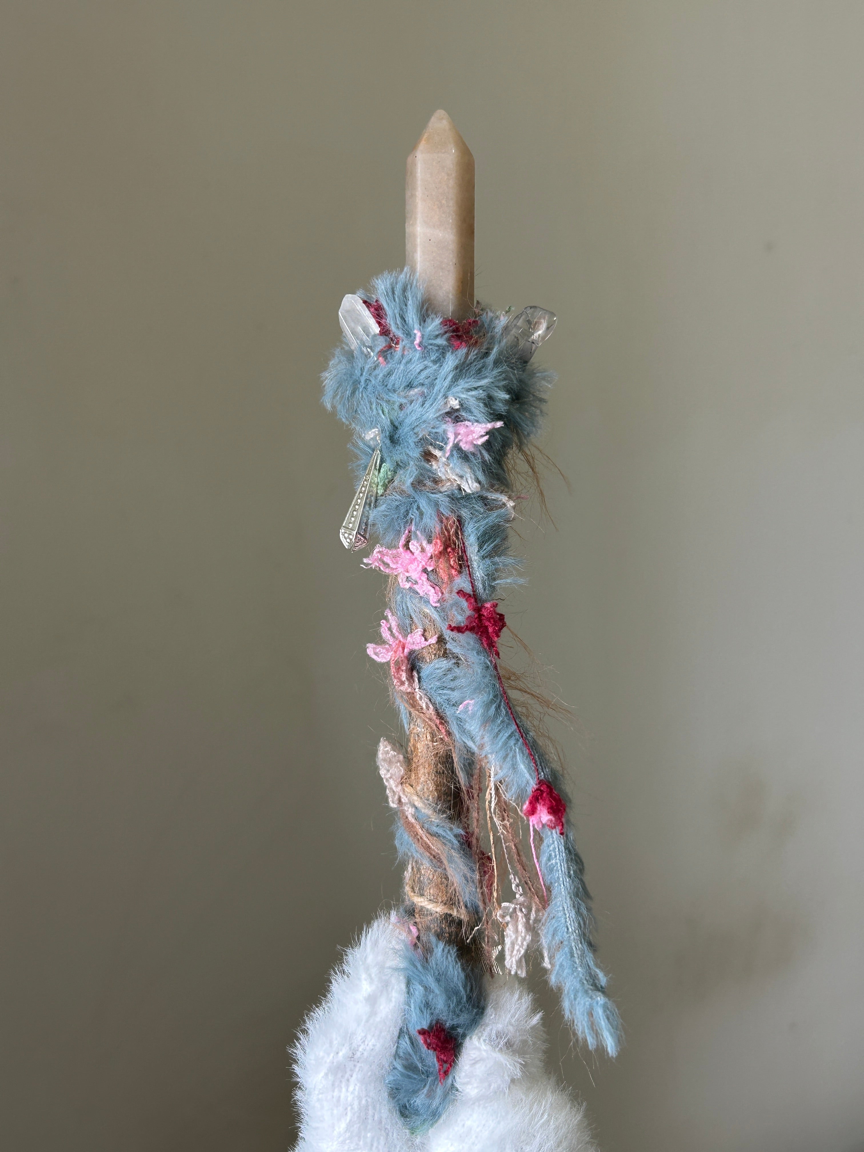 Back view of bright wand with star charm and soft colorful threads