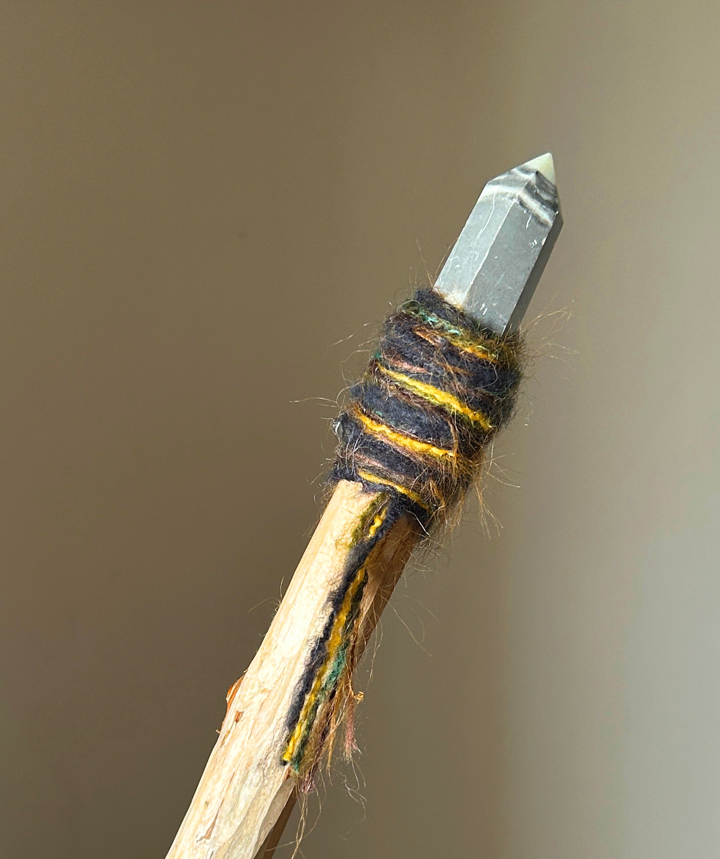 Back view showing natural wood texture, embedded agate drop, and grounding fibers