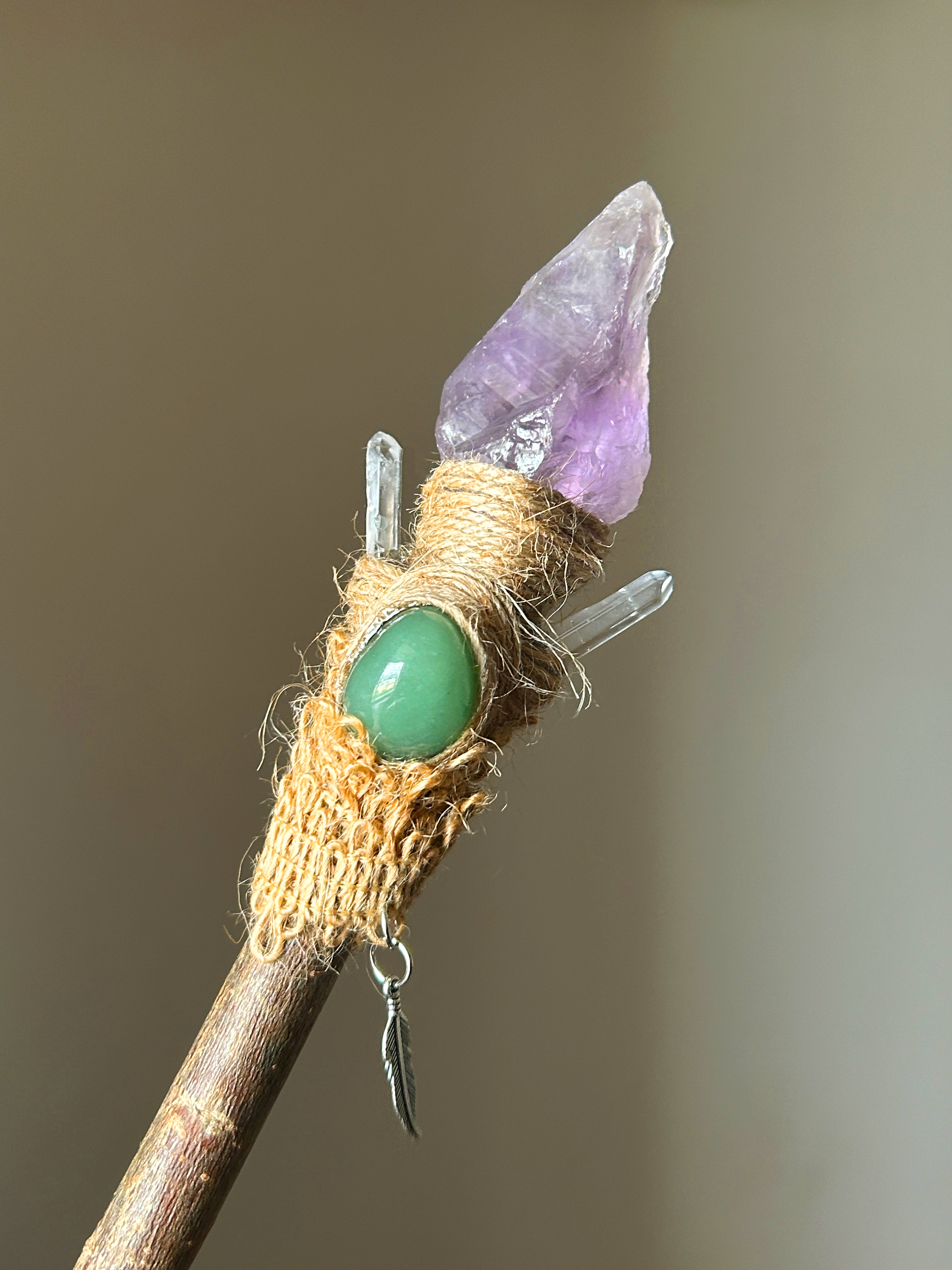 Close-up of amethyst point, aventurine cabochon, and twine fiber handle with quartz