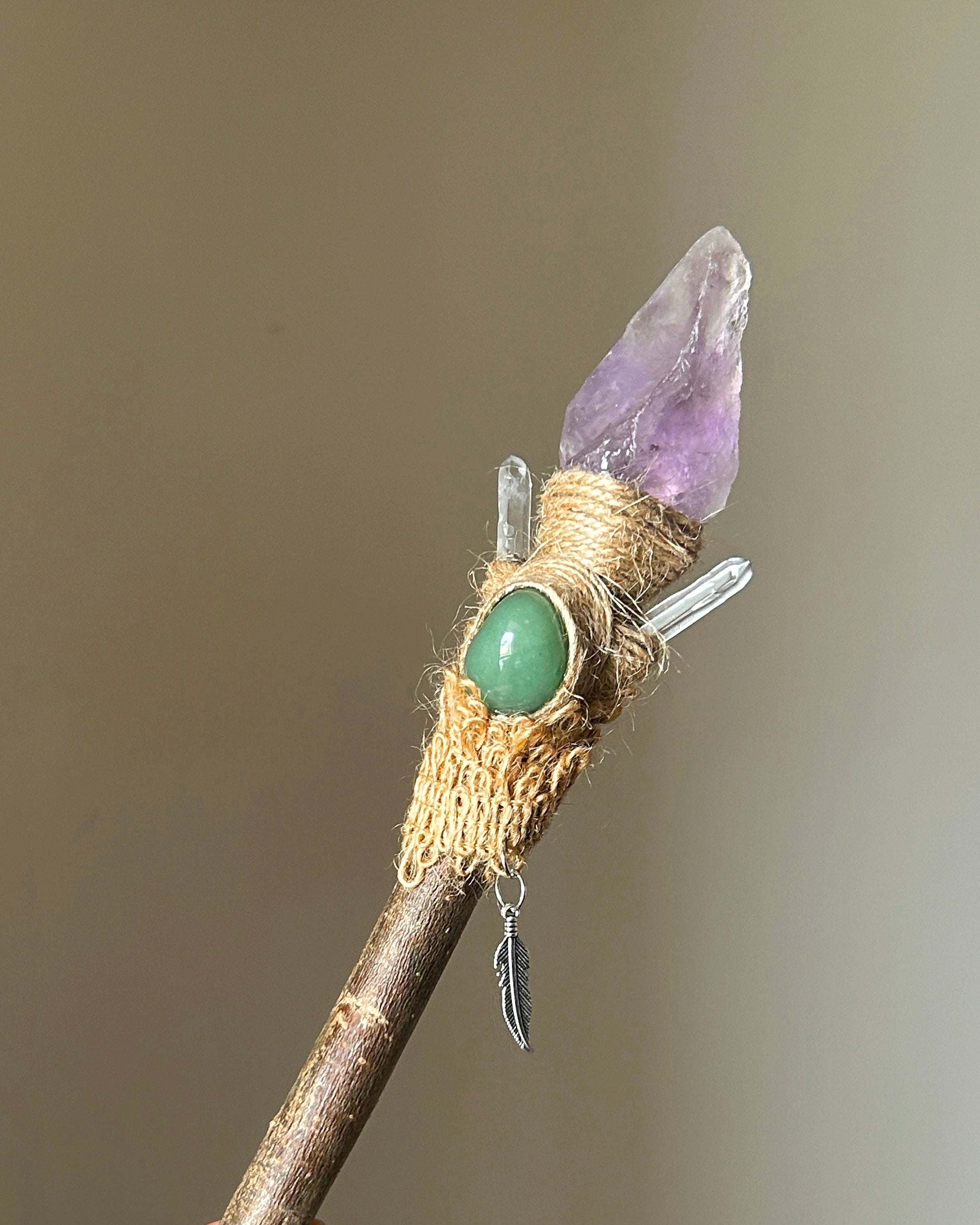 Front view of willow wand with raw amethyst, aventurine accent, and feather charm