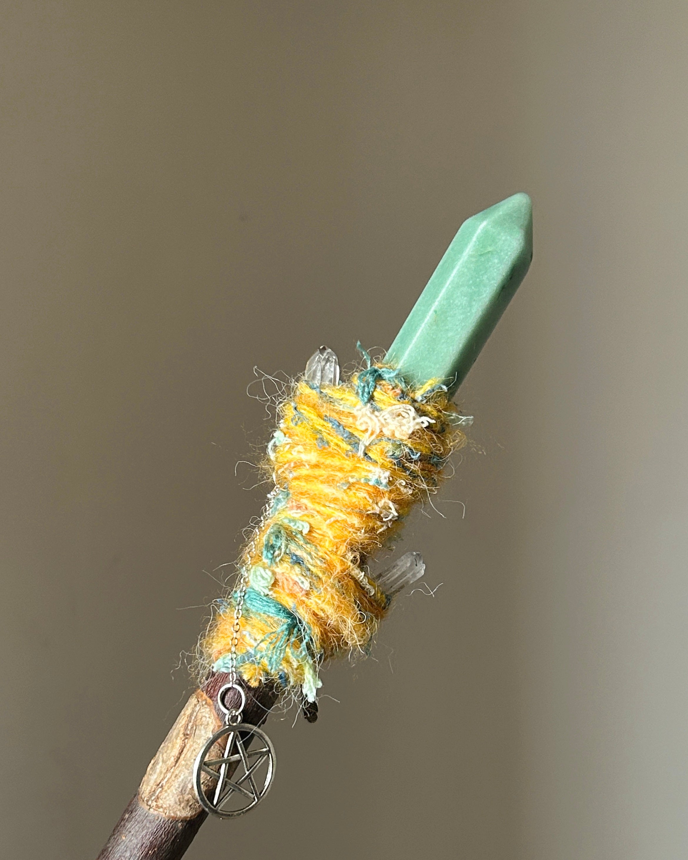 Back view of wand with olive agate center, quartz accents, and silver pentacle charm