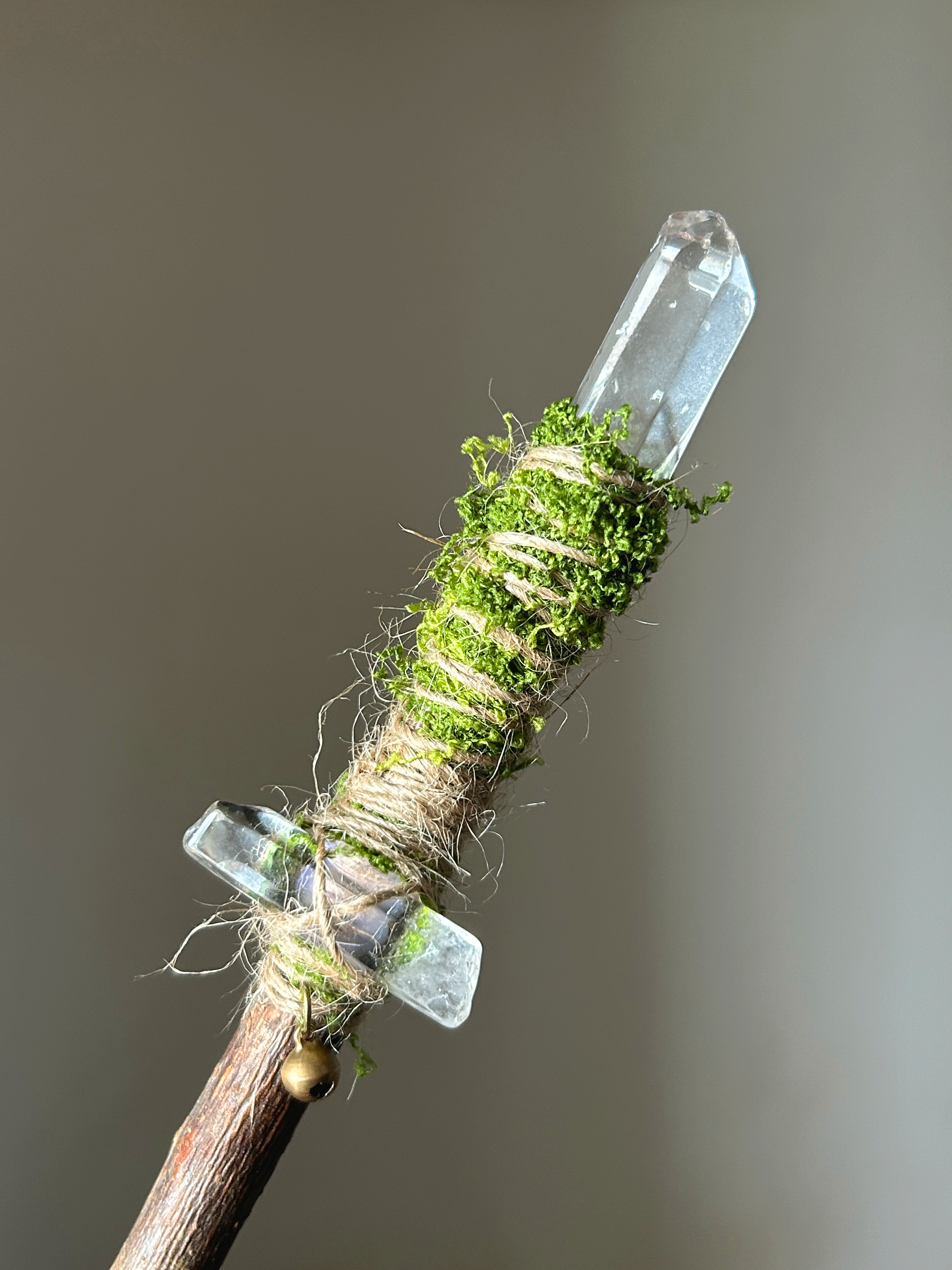 Close-up of the quartz tips, moss, and twine wrapping on a willow wand
