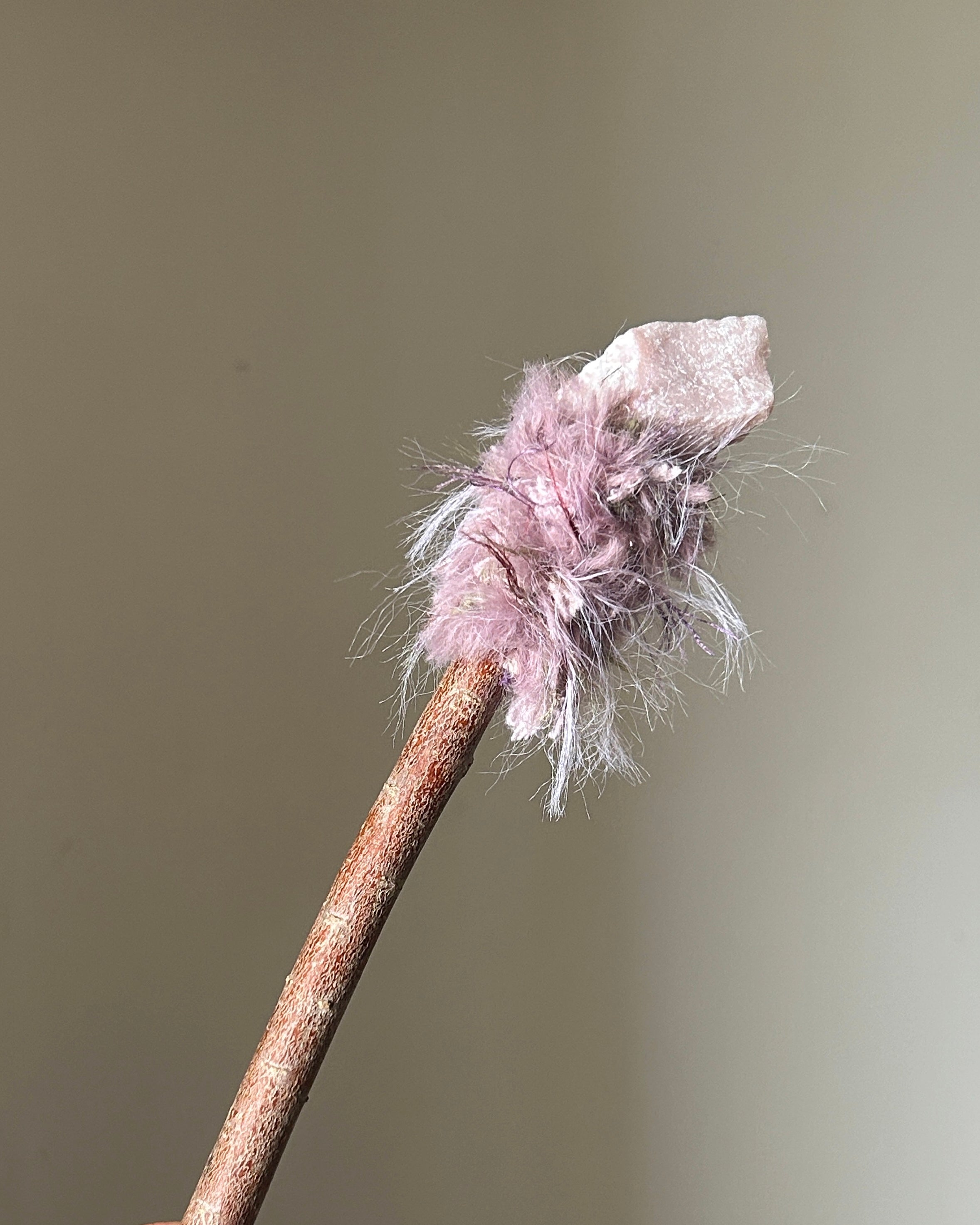 Front view of willow wand with raw pink opal and dusty pink fiber wrapping