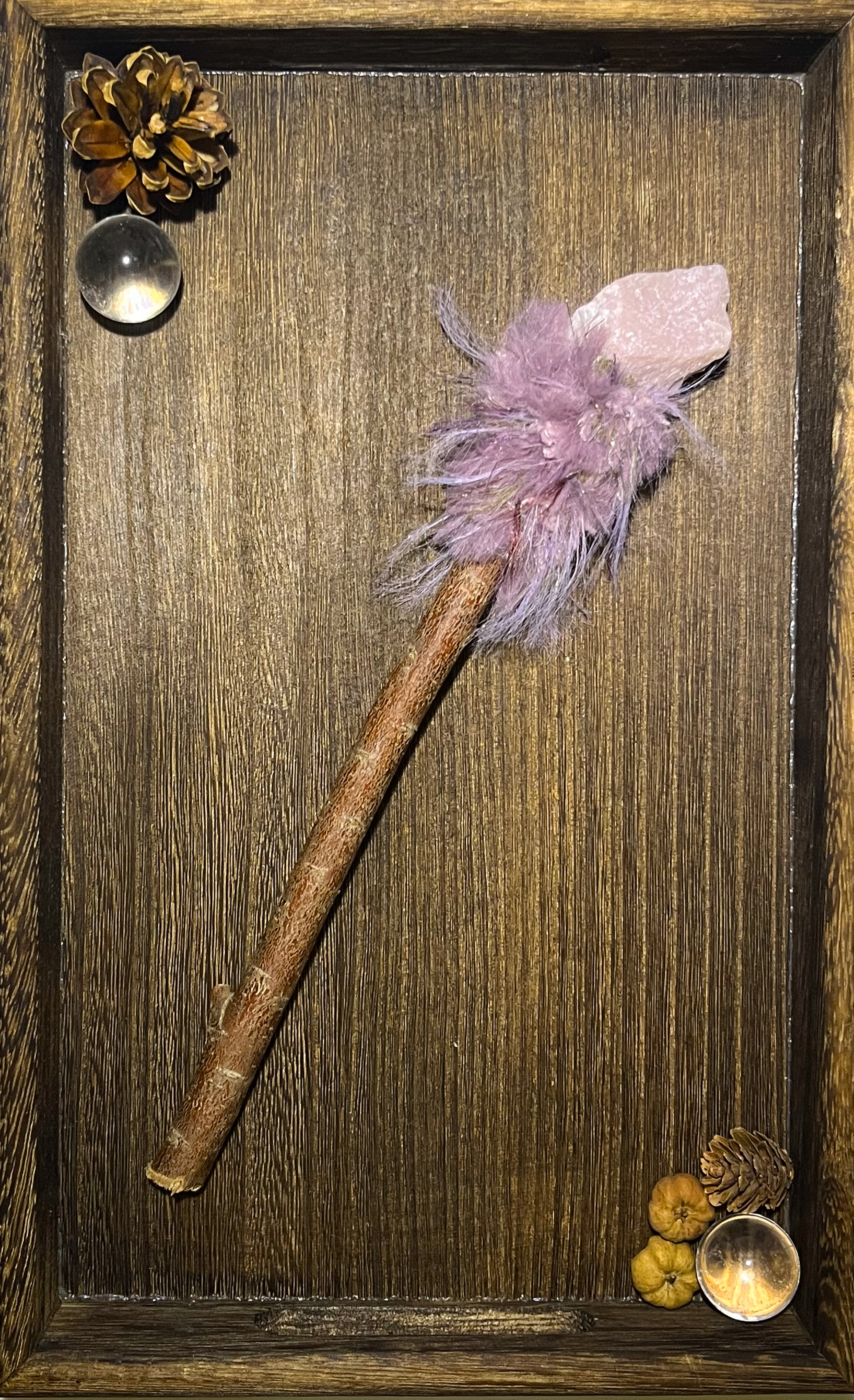 Flat lay of emotional healing wand with pink opal and soft pastel yarn