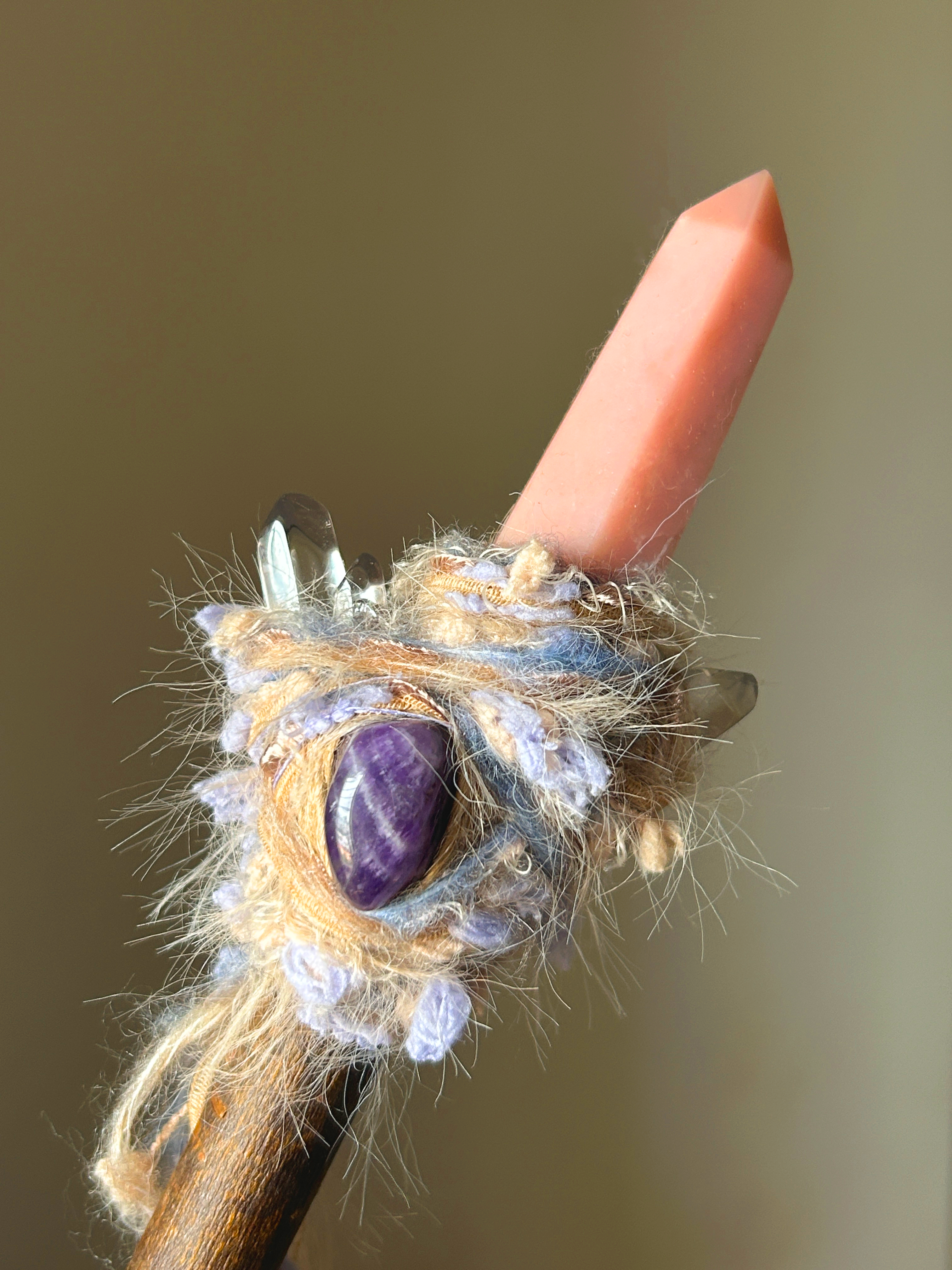 Close-up of pink opal tip, amethyst and apatite stones with lavender yarn wrap