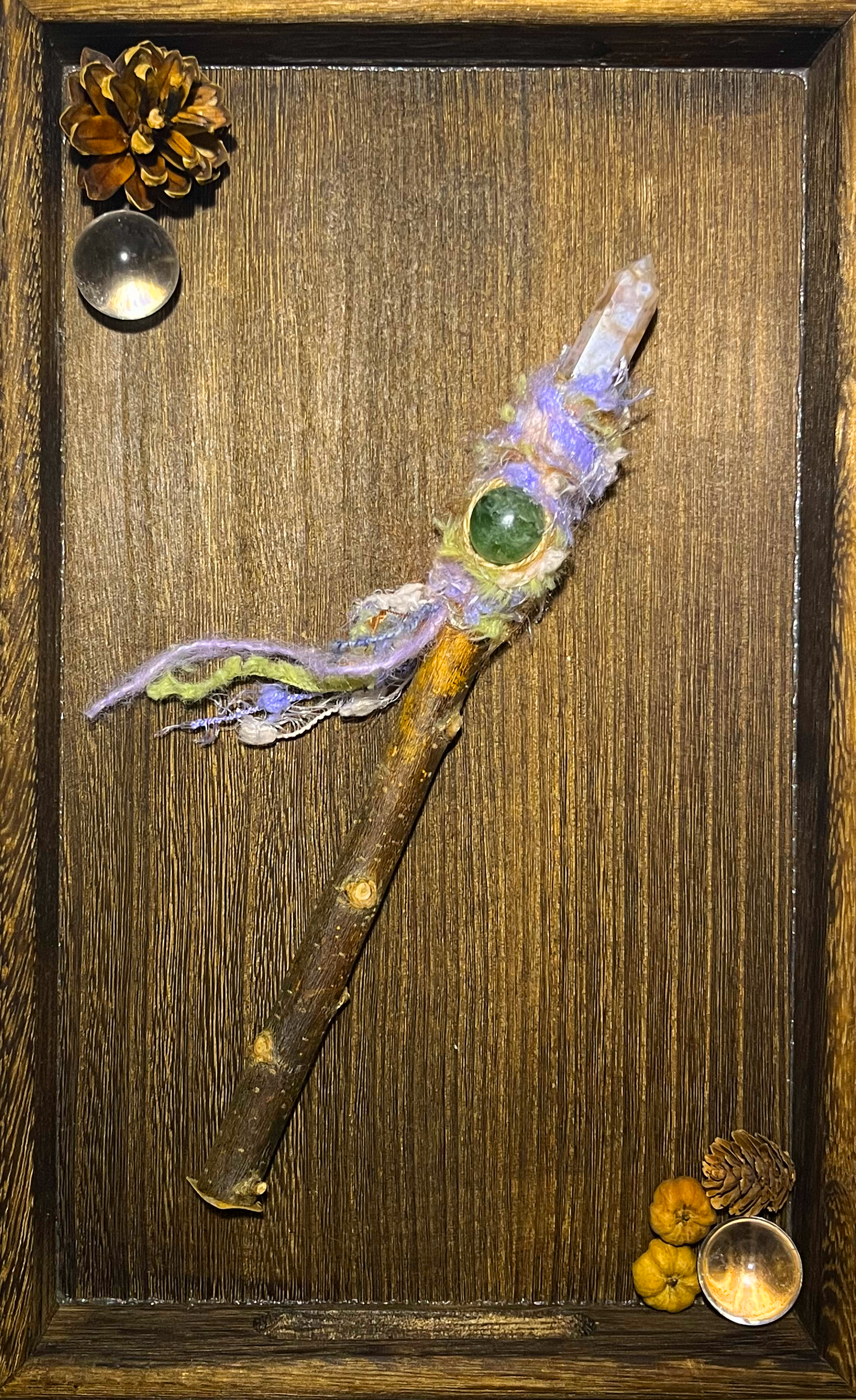 Flat lay of spring-themed wand with Sakura Agate and soft fiber texture on ceramic plate