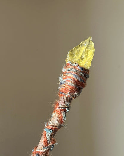 Back view of fire-themed wand with applewood grain and detailed fiber wrapping