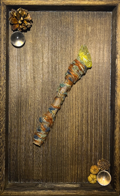 Flat lay of raw citrine wand on ceramic plate with warm sunlight