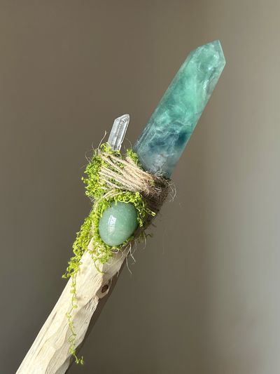 Close-up of fluorite crystal tip, aventurine accent, and earthy fiber handle