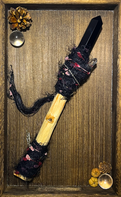 Flatlay showing full wand with obsidian point and crimson threadwork