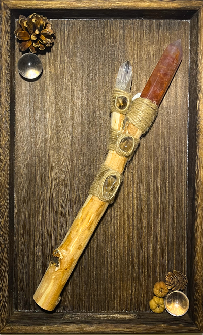Flat lay of orange fluorite and smoky quartz ritual wand for discipline magic