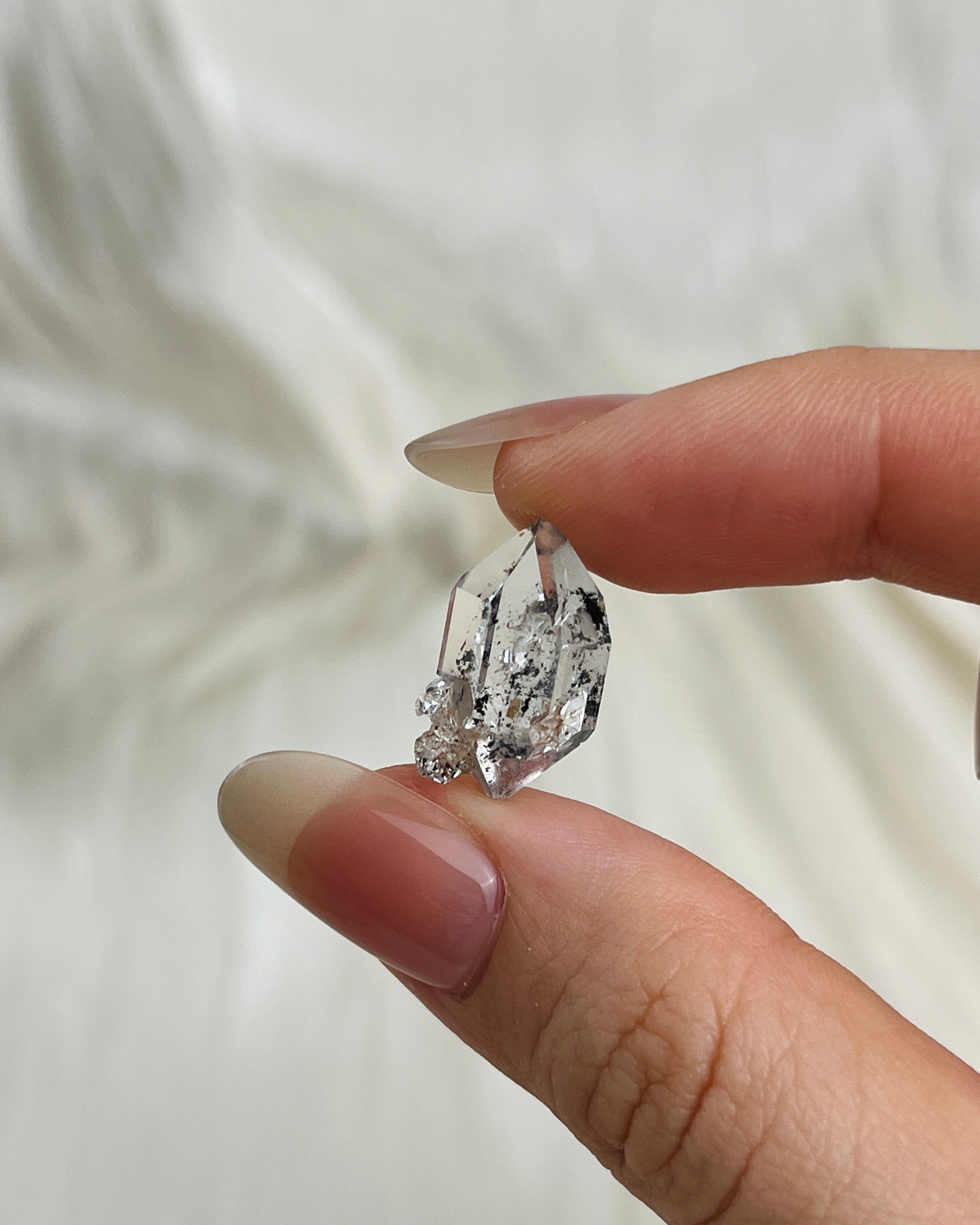 Water-clear Chongqing Diamond Quartz with rainbow reflections, calcite inclusion, and natural pit marks from China1