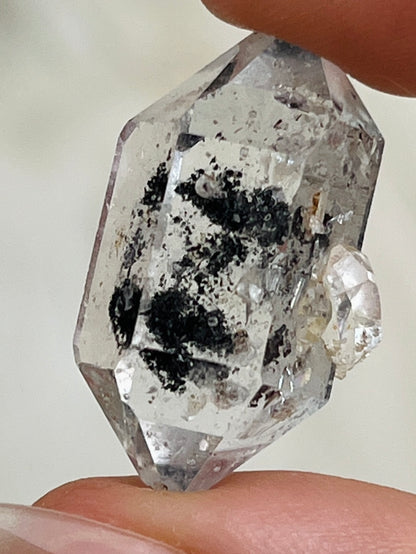 Transparent Chongqing Diamond Quartz with inky phantom inclusion aligned to outer edges and small rider crystal from China