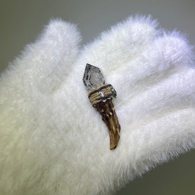 Close-up of Ink Phantom Quartz crystal on antler wand, front view