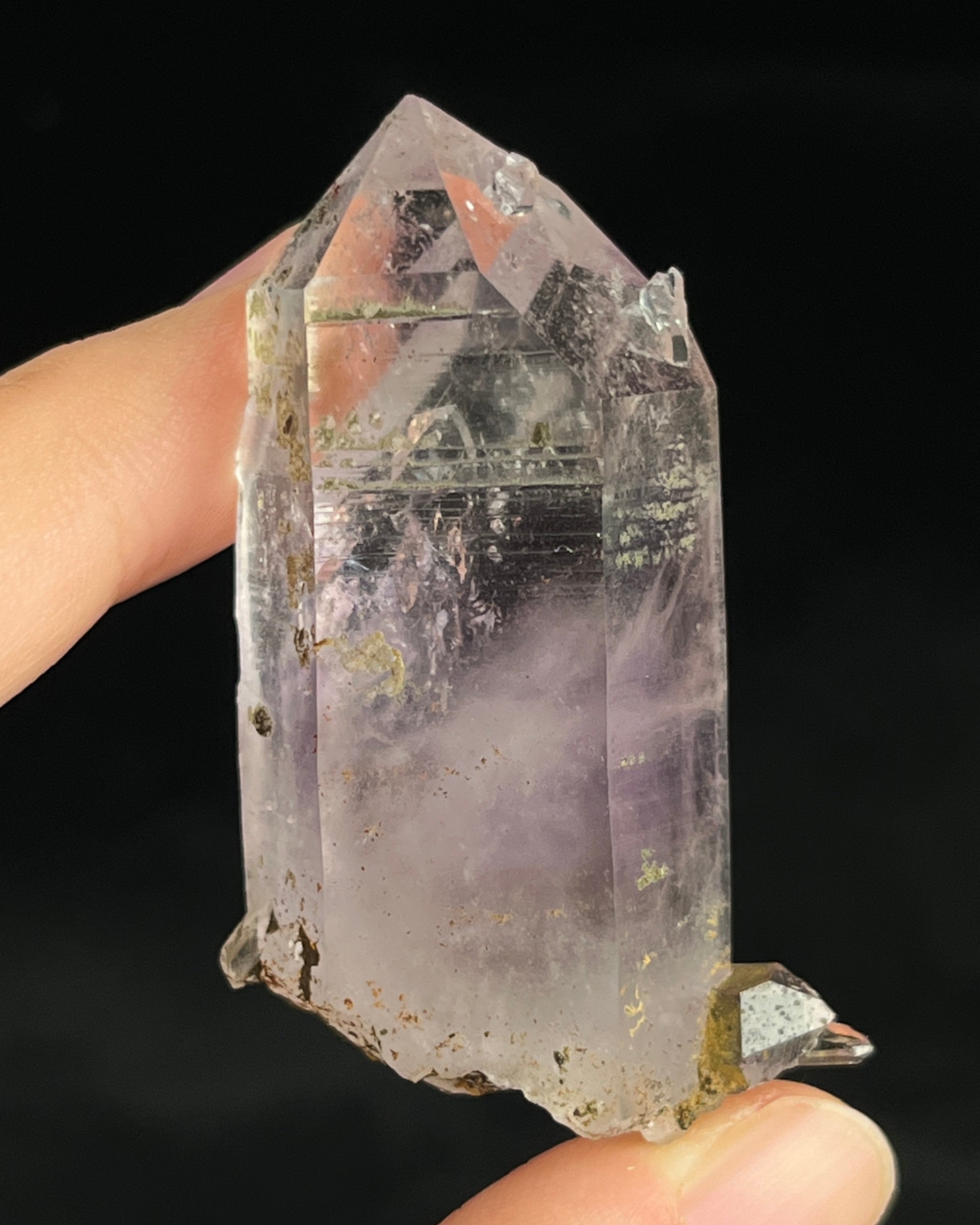Soft lavender amethyst with self-healed regrowth crystals and a light chlorite coating near the base.
