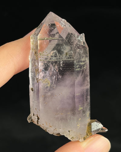 Soft lavender amethyst with self-healed regrowth crystals and a light chlorite coating near the base.