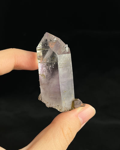 Soft lavender amethyst with self-healed regrowth crystals and a light chlorite coating near the base.1