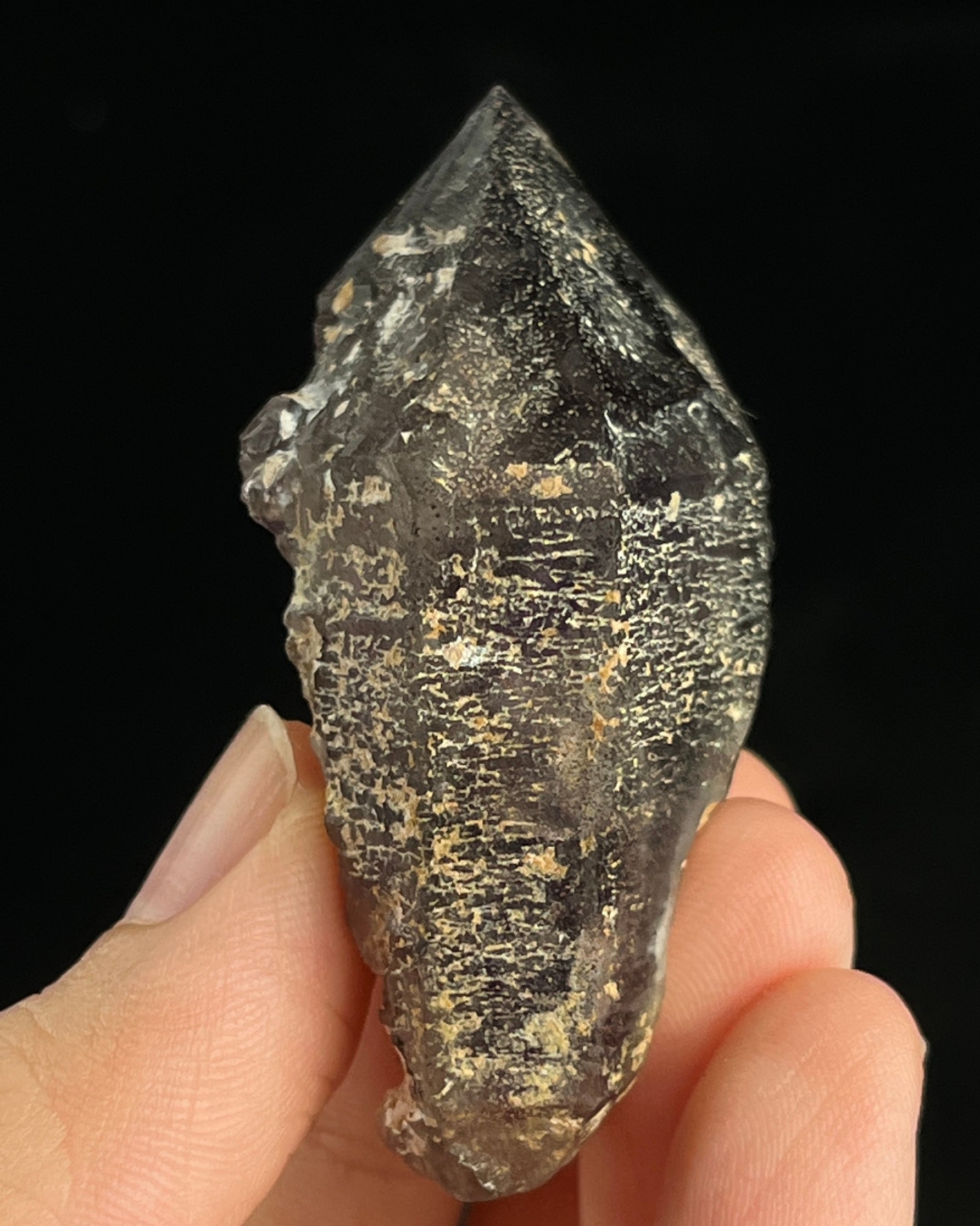 Namibian amethyst with violet core and etched crocodile-textured surface, showing dark micro-inclusions.