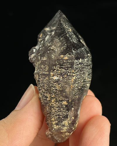 Namibian amethyst with violet core and etched crocodile-textured surface, showing dark micro-inclusions.