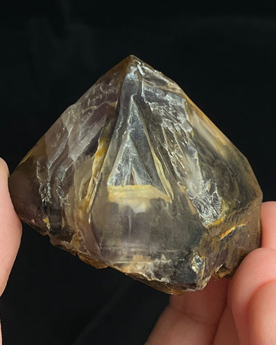 Natural Namibian skeletal amethyst specimen with etched “mountain” formations and smoky-violet zoning.