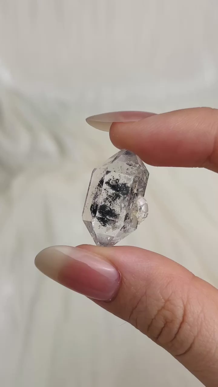 Load video: Transparent Chongqing Diamond Quartz with inky phantom inclusion aligned to outer edges and small rider crystal from China video