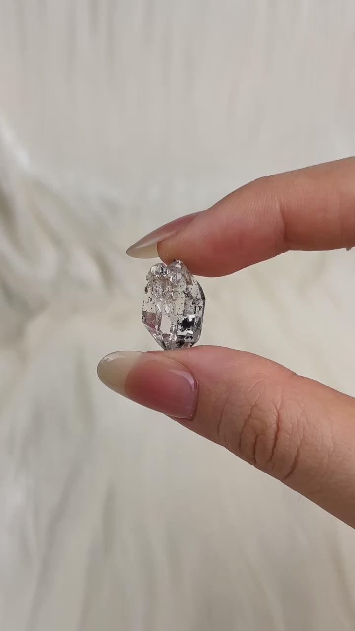 Load video: Water-clear Chongqing Diamond Quartz with rainbow reflections, calcite inclusion, and natural pit marks from China video