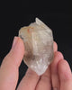 Pale smoky elestial quartz with layered white and reddish clay and companion crystals at the base.video
