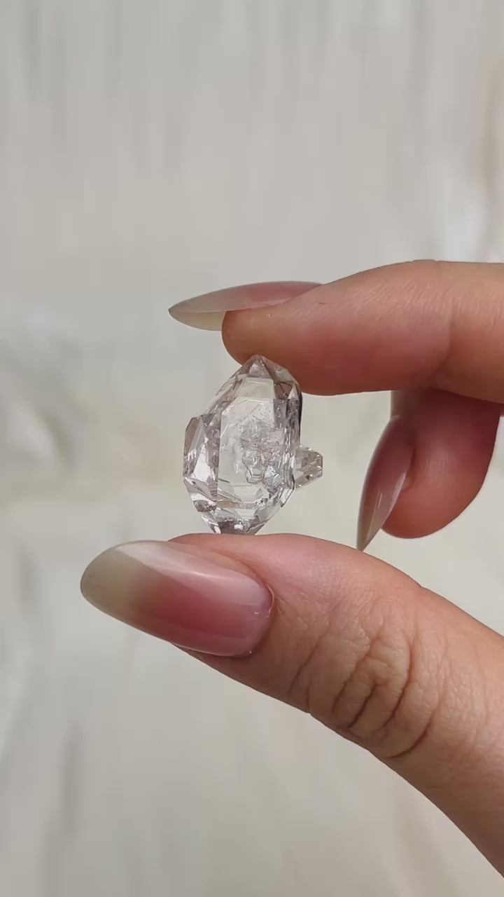 Bright Chongqing Diamond Quartz crystal with a flower-shaped surface mark and a light grey tip from China video