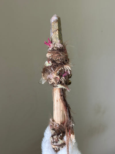 Back view of soft-toned birch wand with fiber wrap and forest details