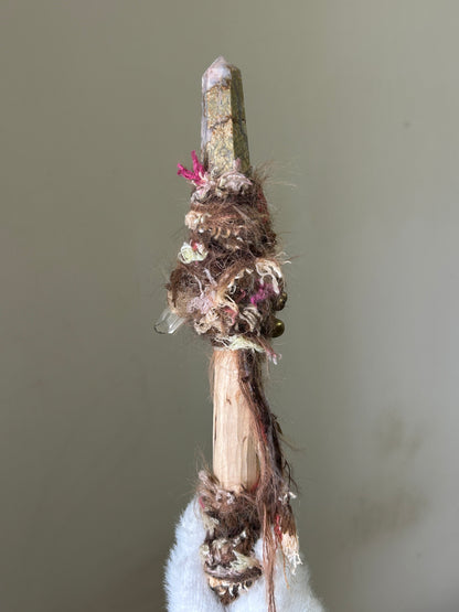 Back view of soft-toned birch wand with fiber wrap and forest details