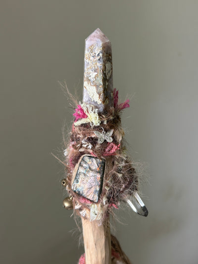 Close-up of sakura agate point, labradorite shard, and butterfly charm