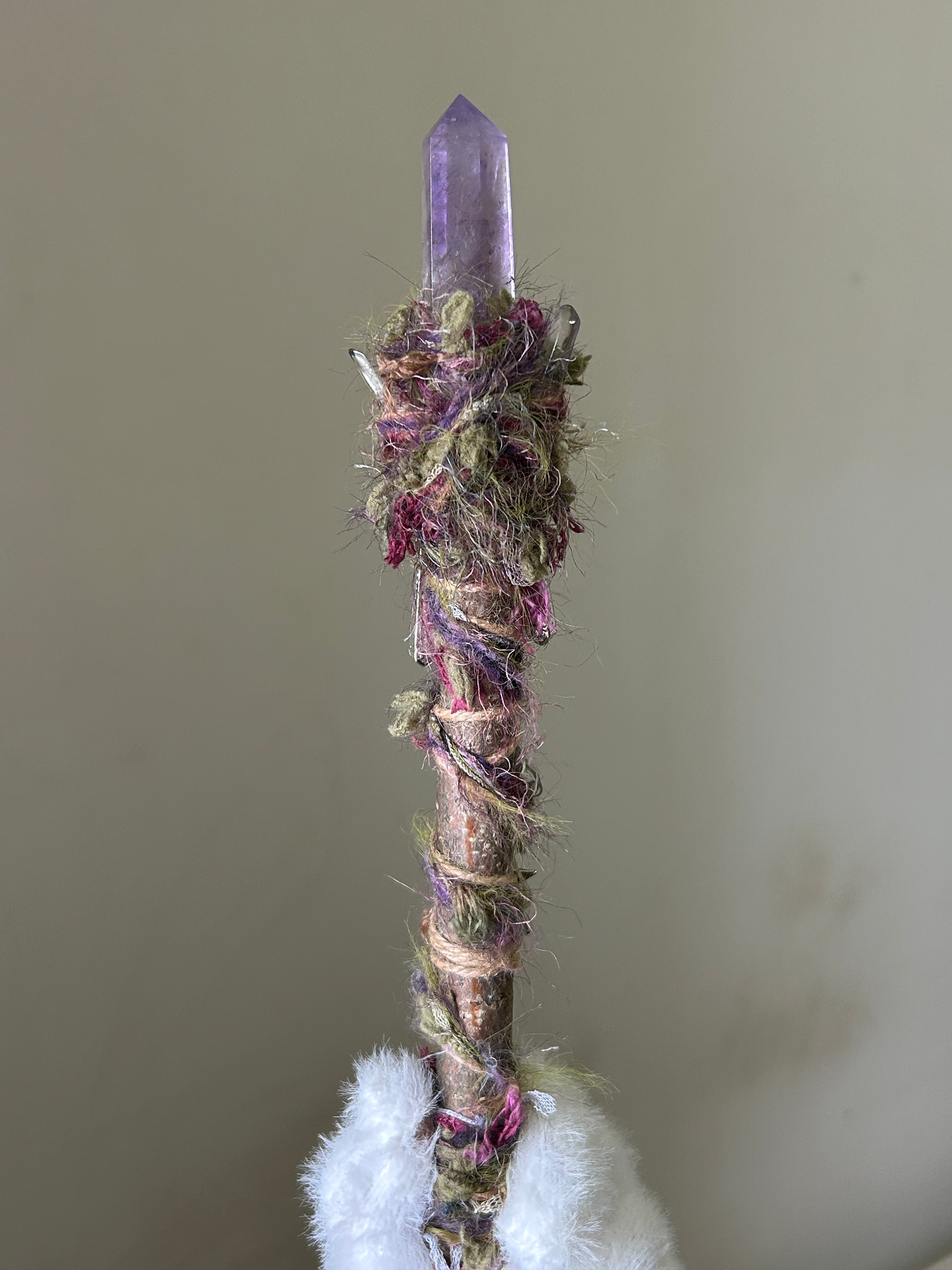 Back view of willow wand with fiber wrapping and star charms