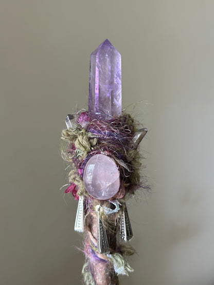 Close-up of amethyst tip and rose quartz sphere on handcrafted wand
